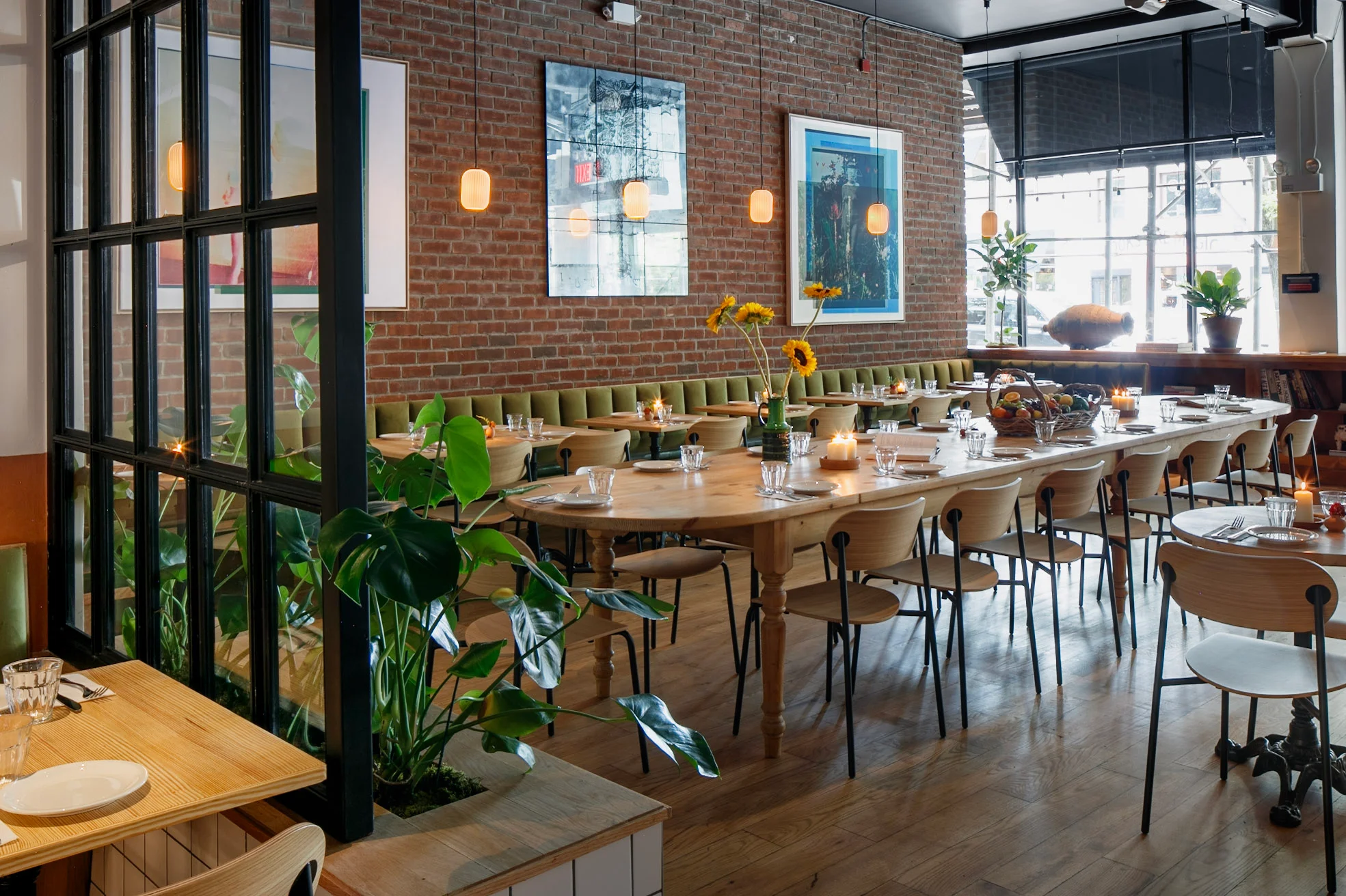 Long dining tables and brick wall at Chama Mama Brooklyn Heights