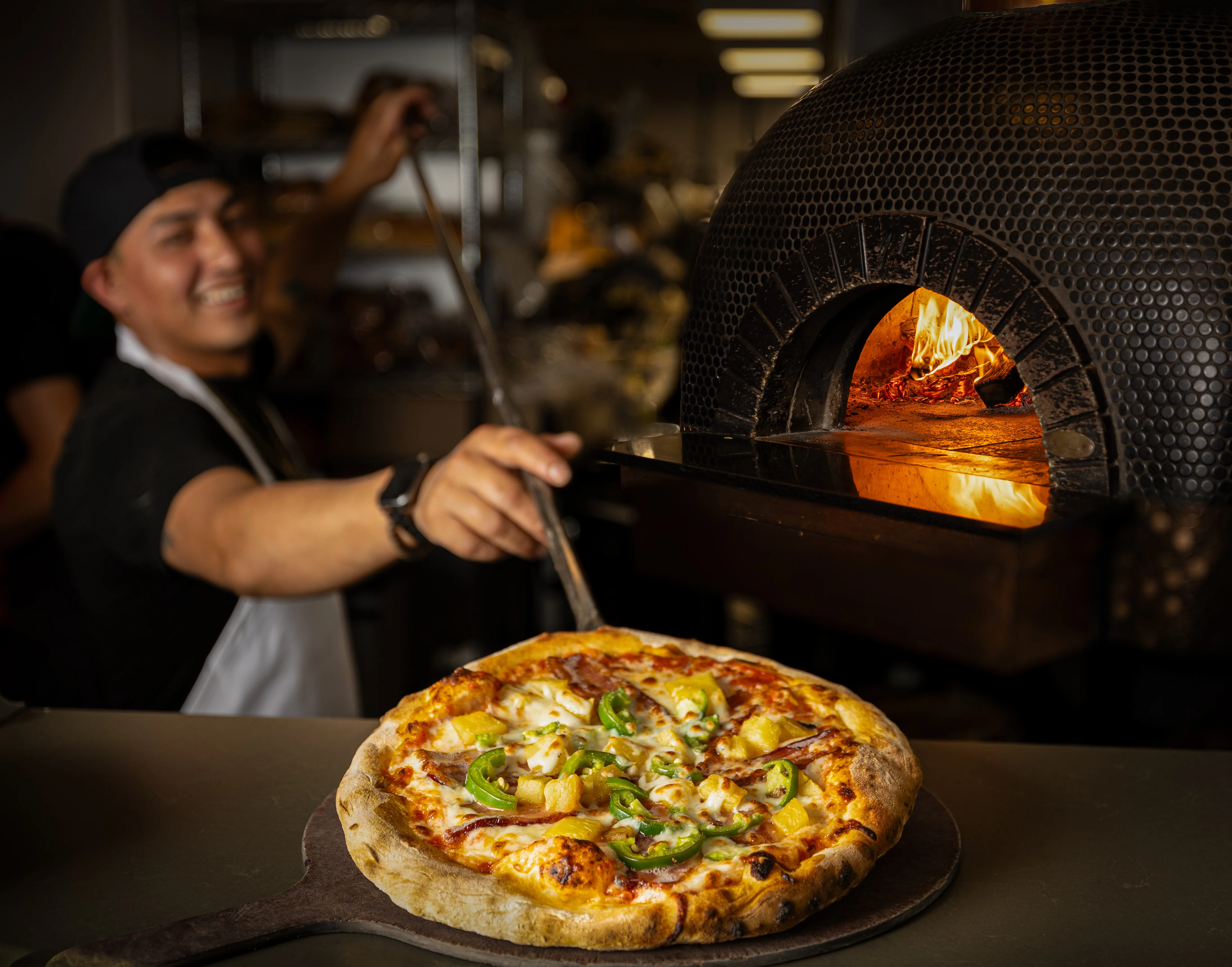 Hawaiian pizza fresh from a wood-fired oven