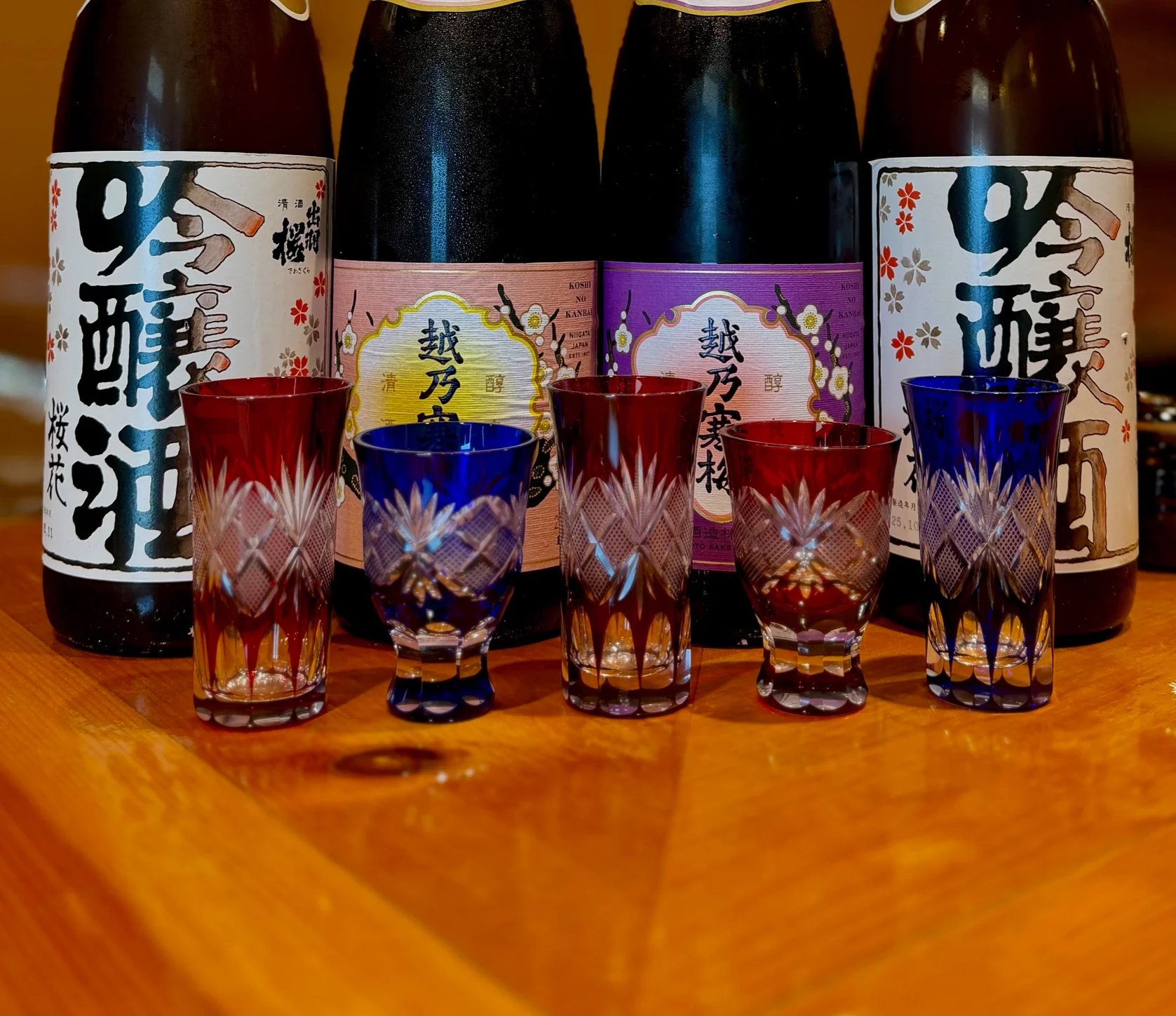 Selection of premium Japanese sake bottles with decorative glasses
