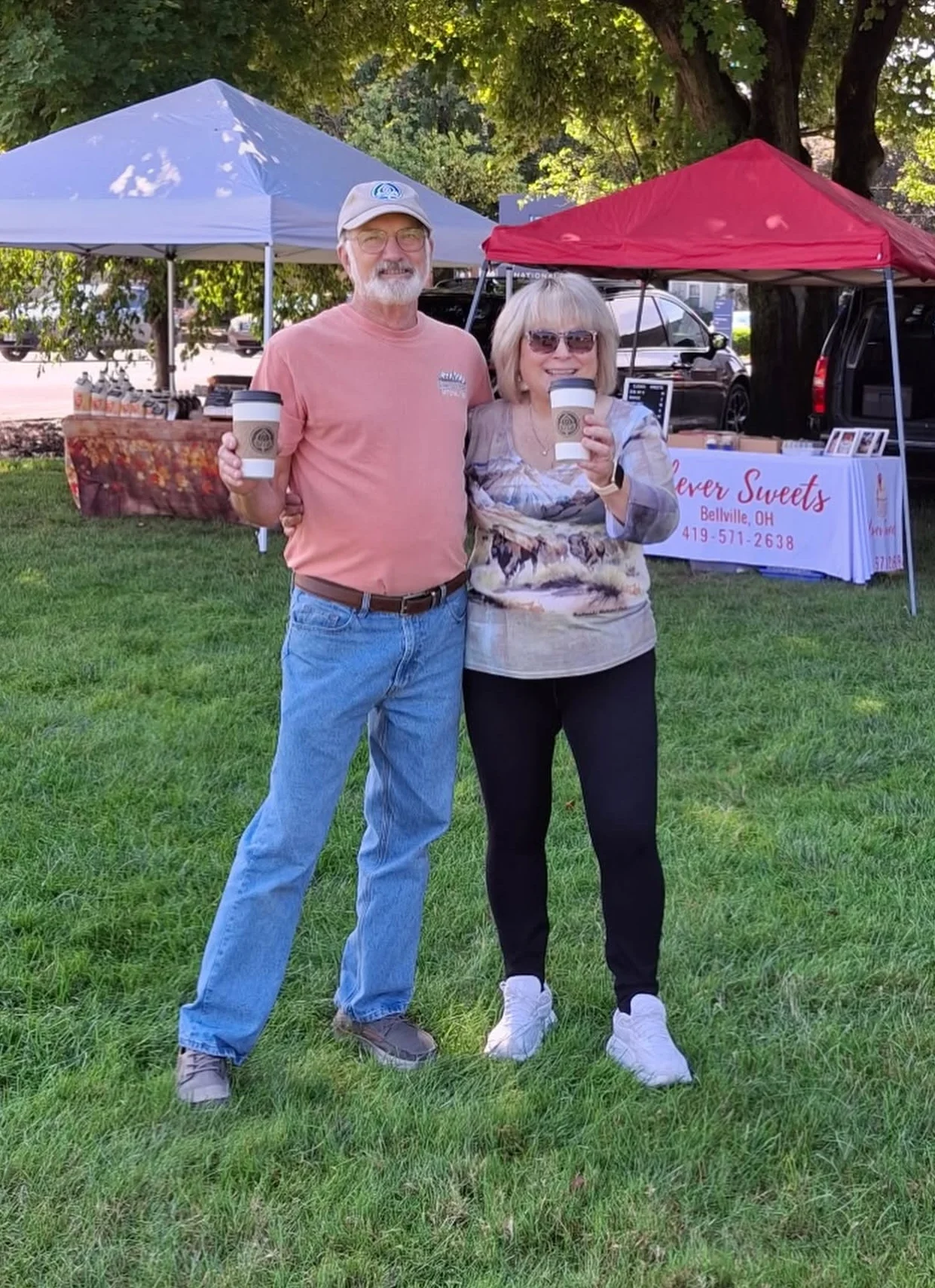 Couple enjoying coffee at a vibrant outdoor market