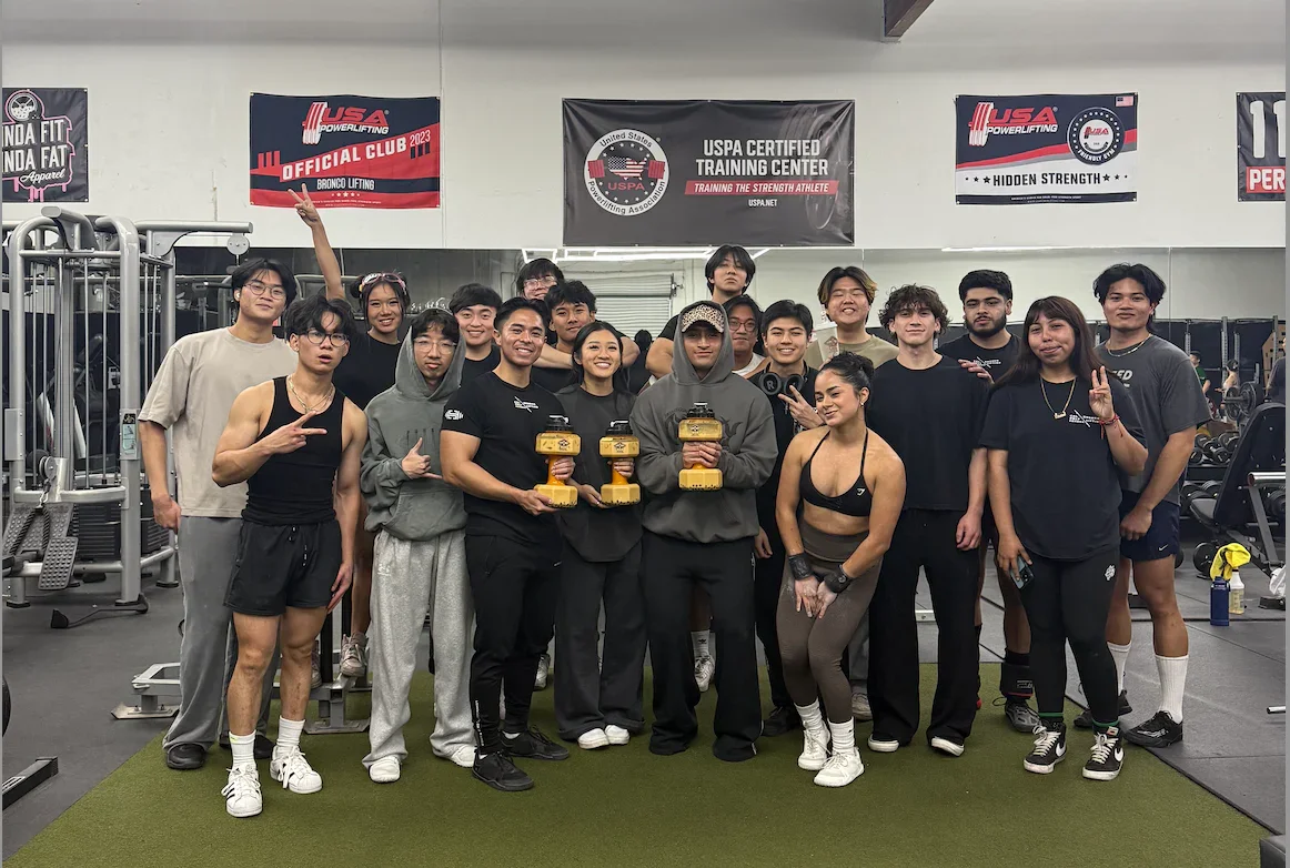 Group photo of powerlifting team celebrating their achievements