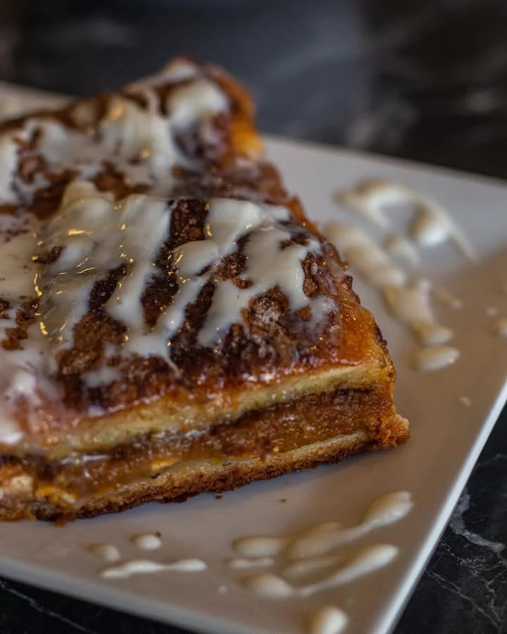 Cinnamon roll bread pudding drizzled with icing