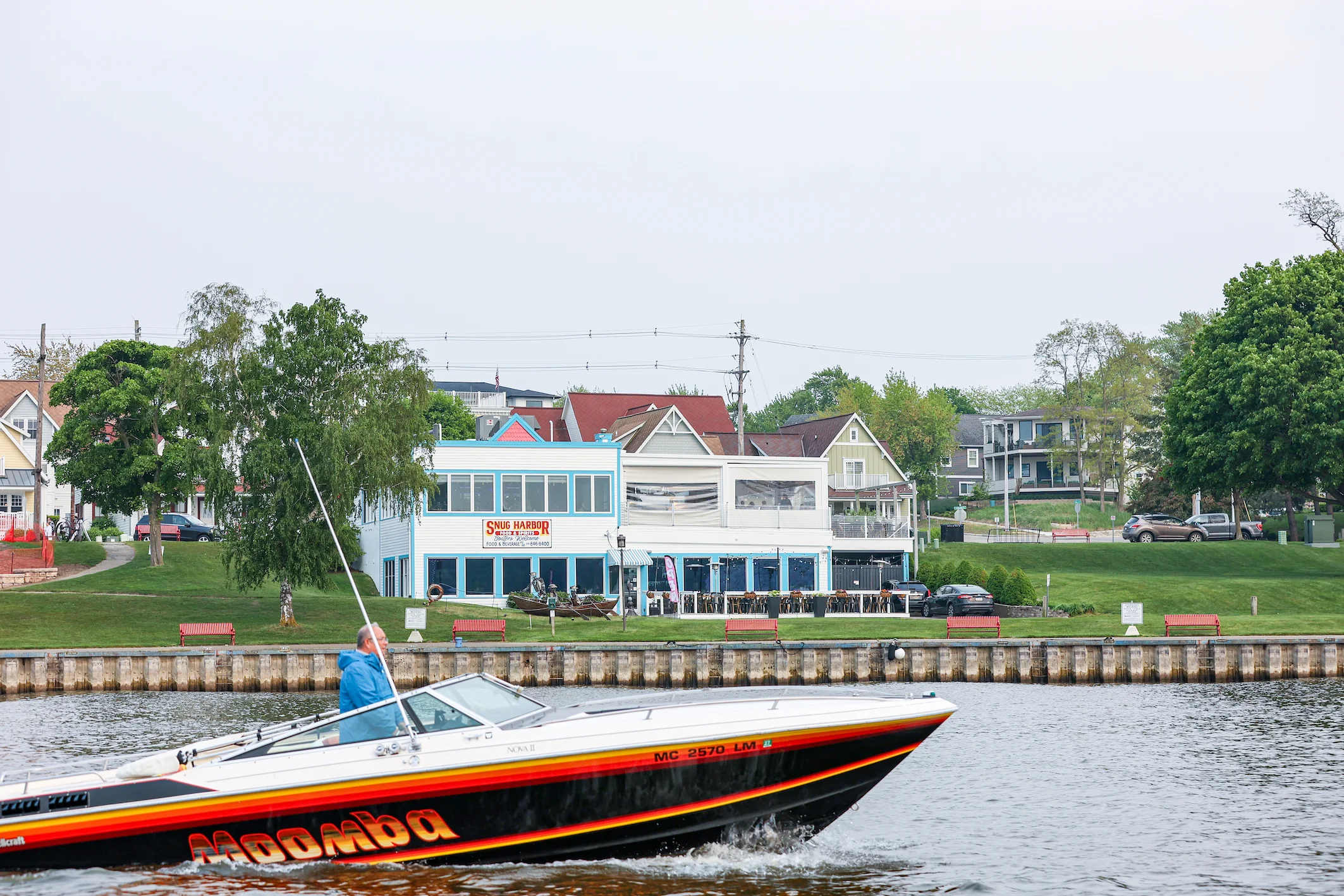View of Snug Harbor restaurant by the water with boats