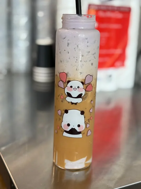 Colorful bubble tea in a cute panda-themed cup