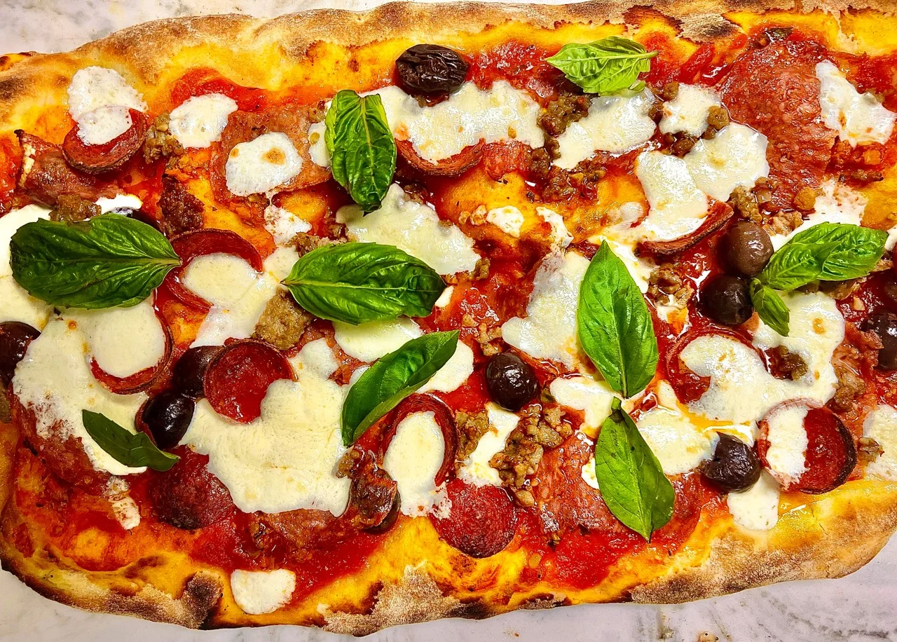 Pepperoni pizza with fresh basil and mozzarella