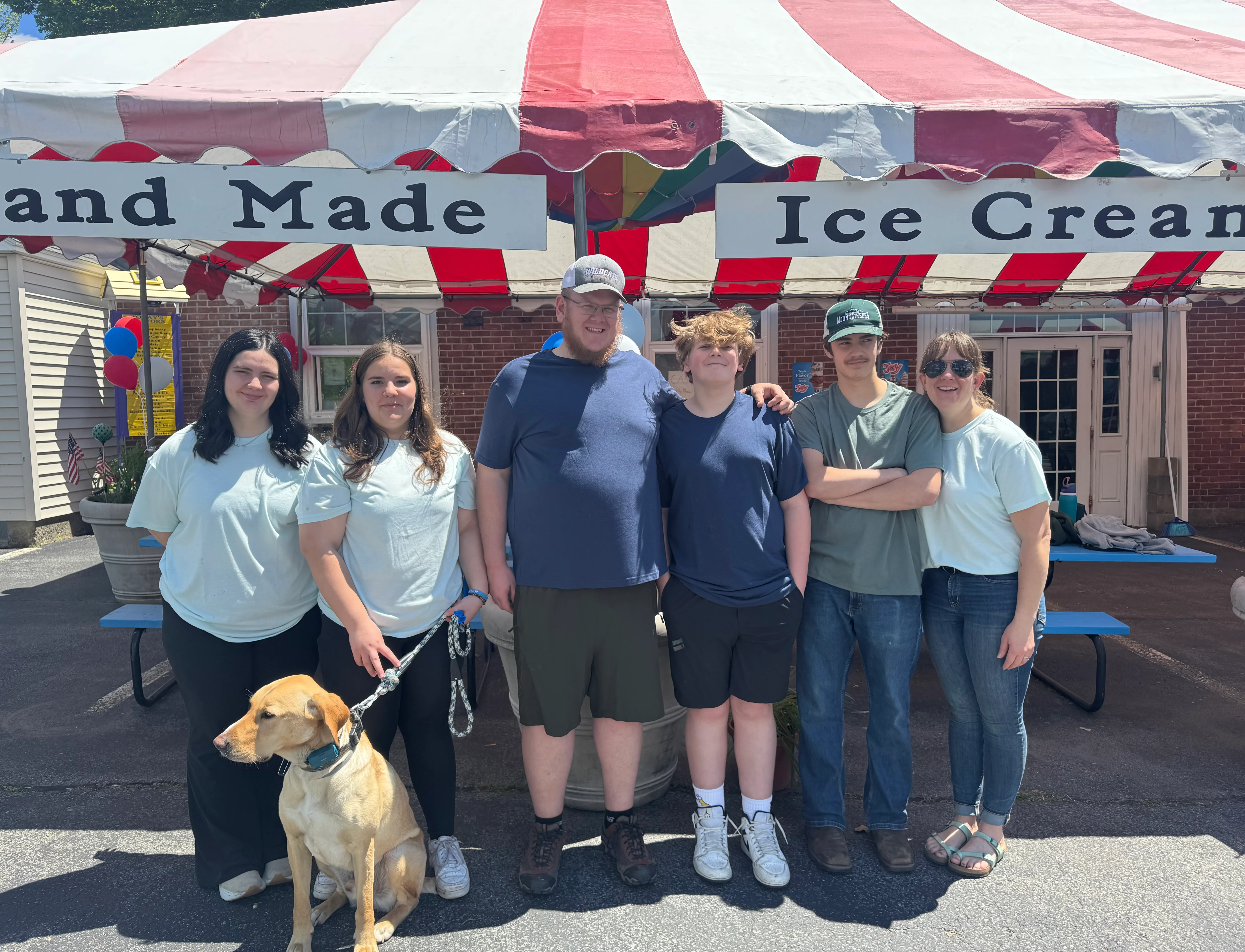 Group of friends at an ice cream stand on a sunny day