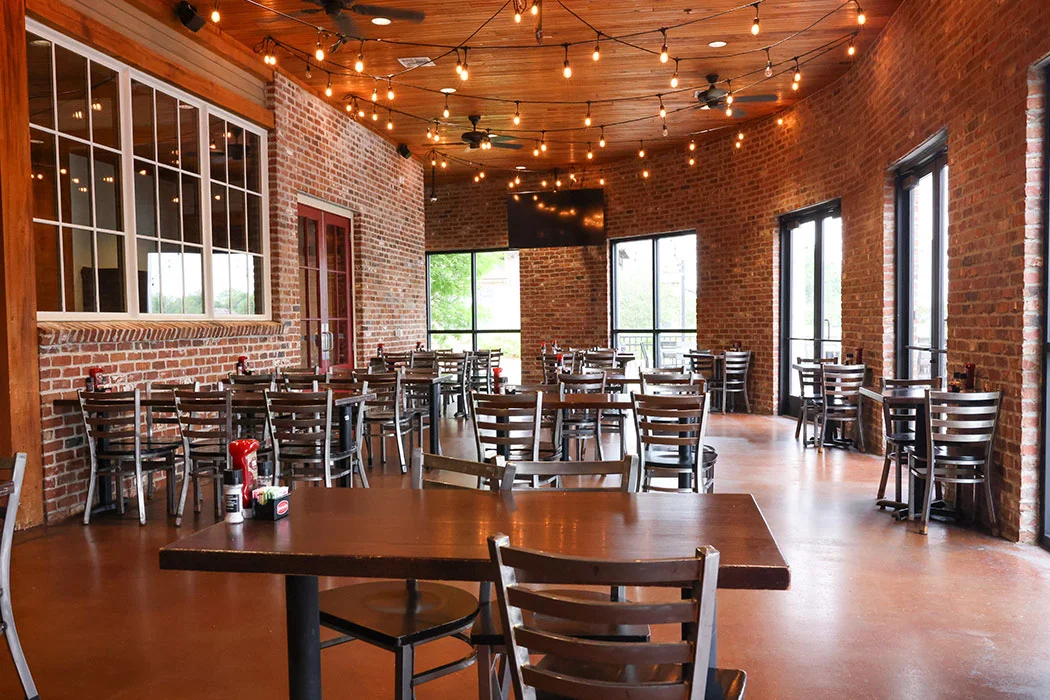 Cozy restaurant interior with exposed brick and warm lighting