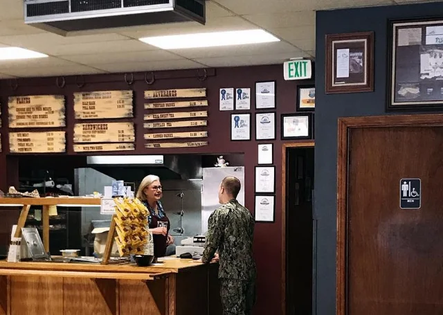 Cozy restaurant interior with a wooden counter and patrons chatting