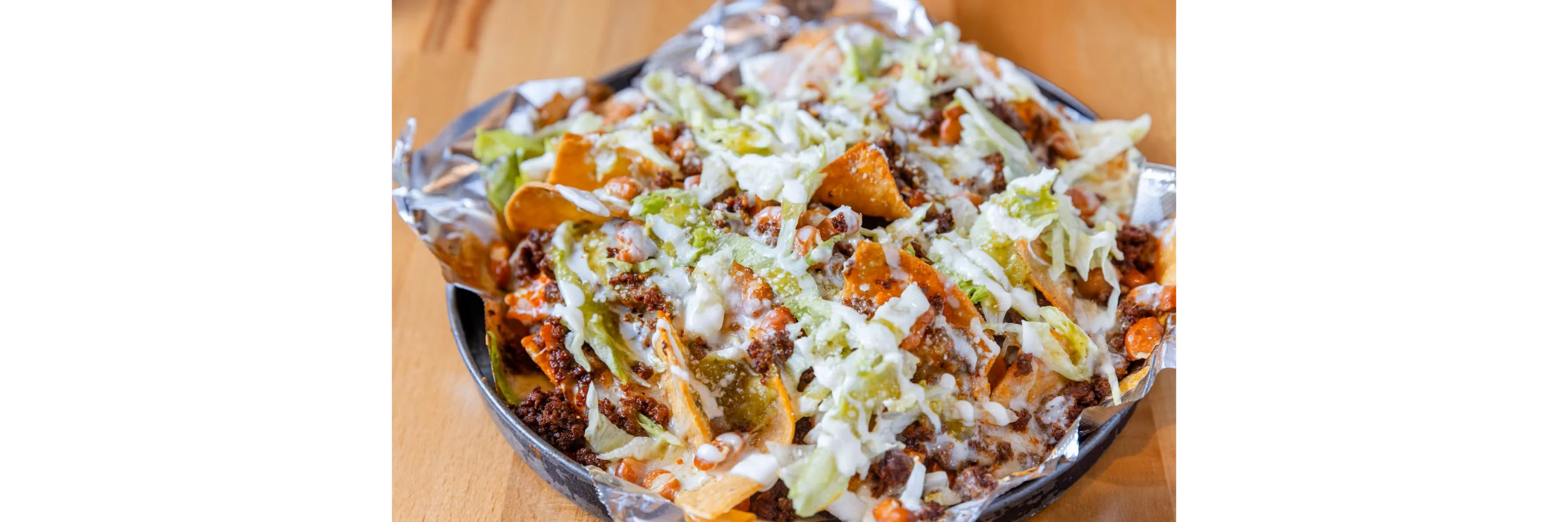 Loaded nachos topped with beef and fresh toppings