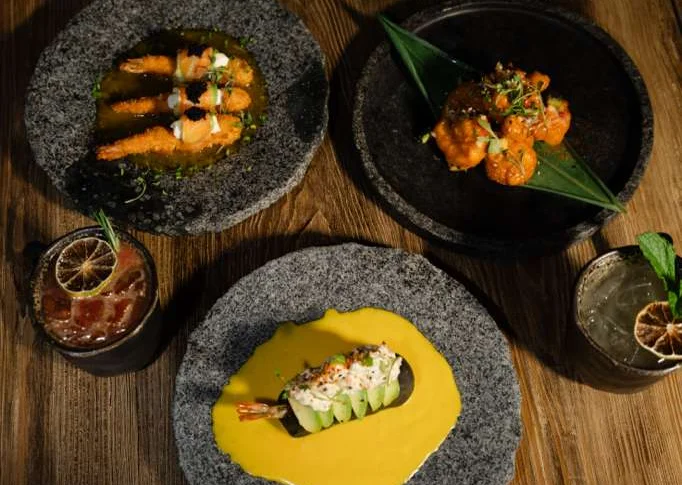 Artistic presentation of Asian fusion shrimp dishes on stone plates