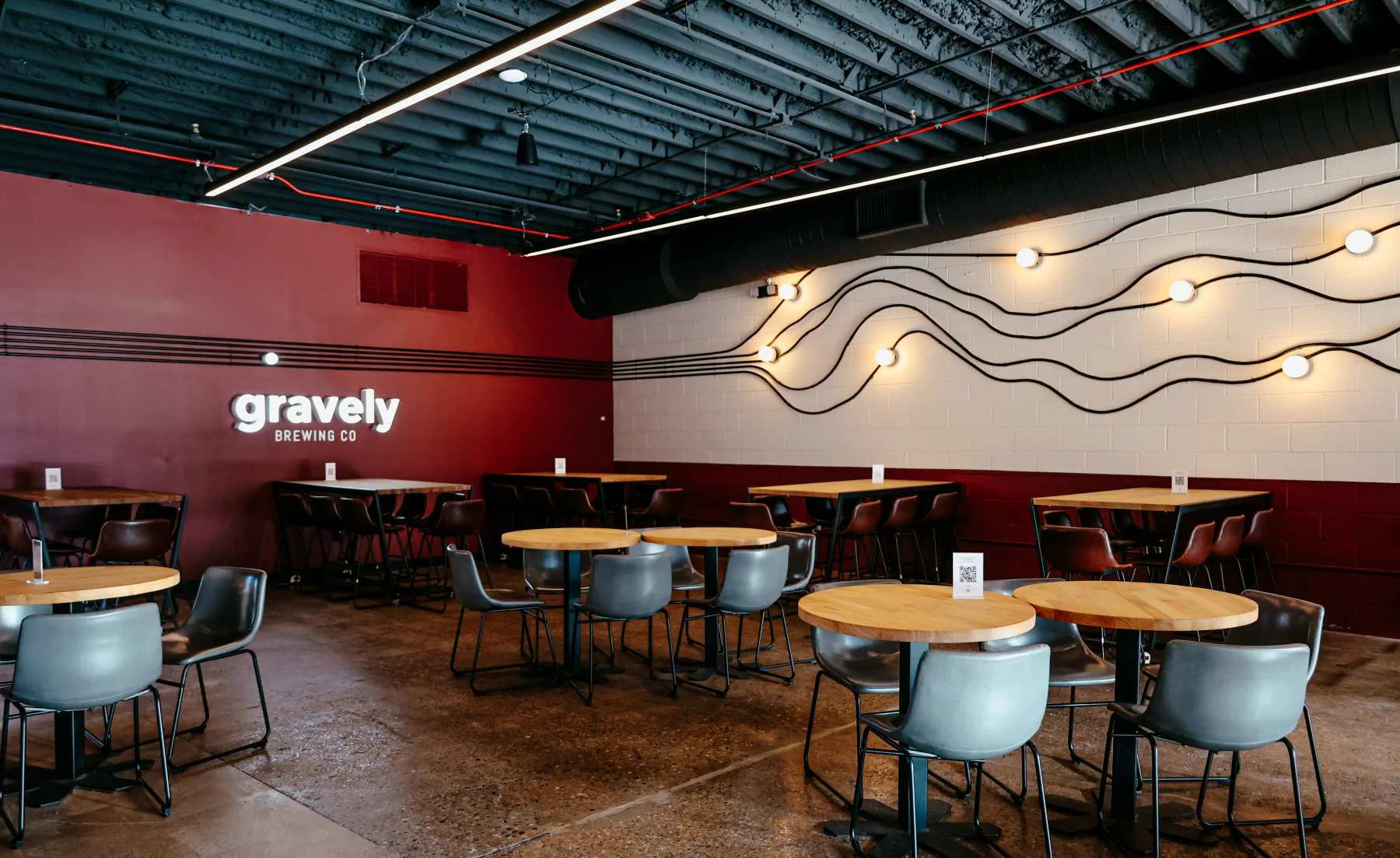 Interior of Gravely Brewing Co. with tables and modern decor.