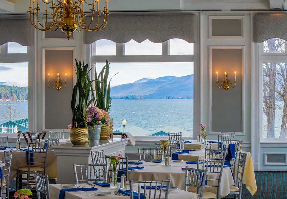Elegant restaurant interior with lake view and floral decor