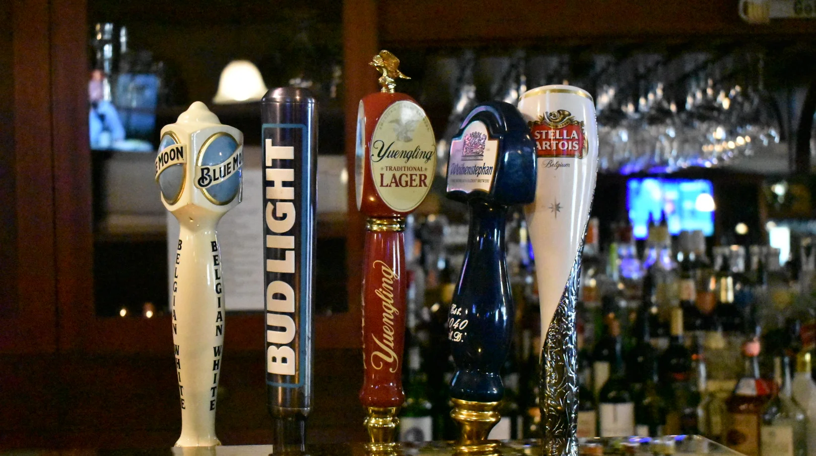 Selection of beer taps at a lively bar