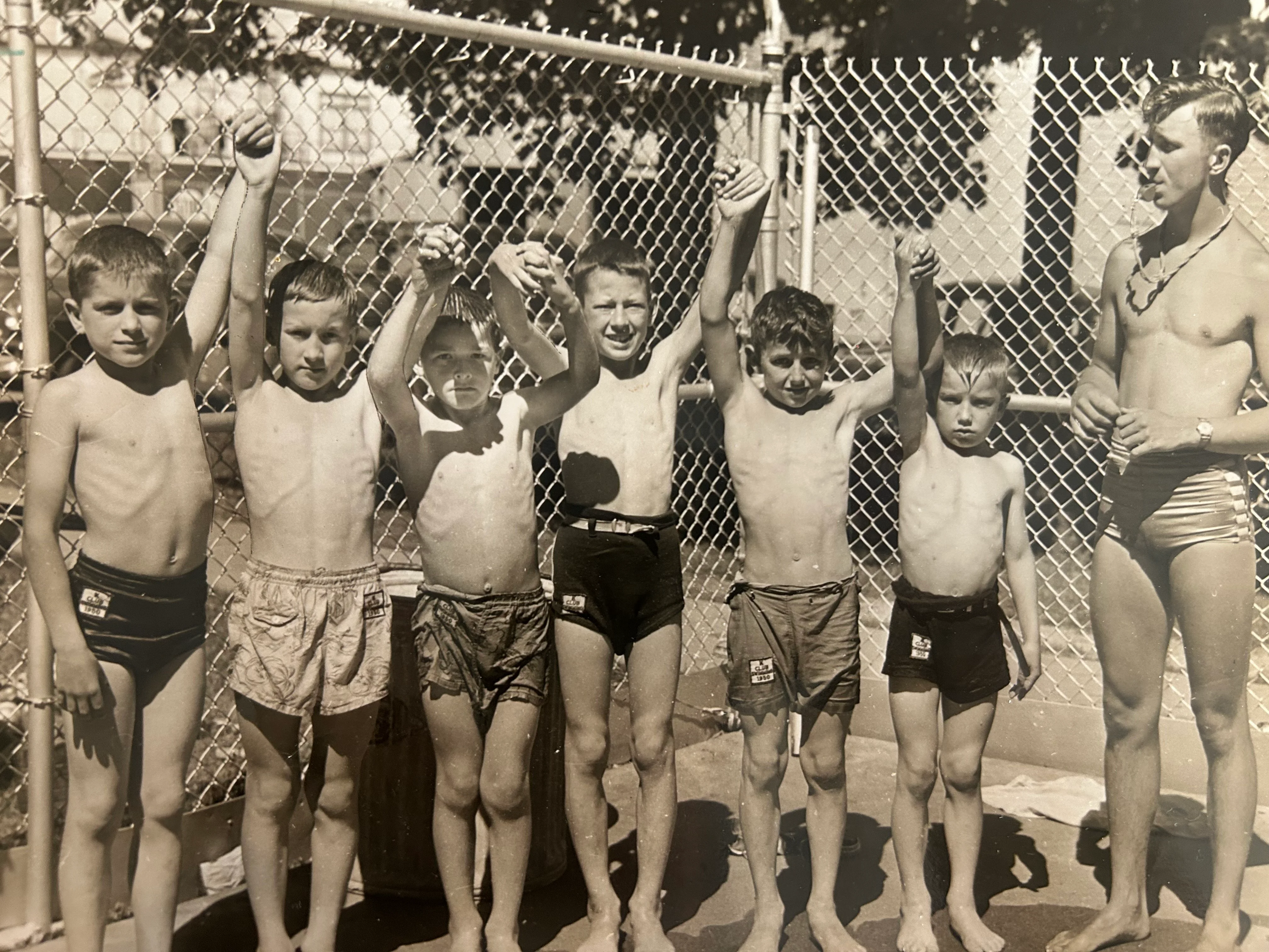 Group of children celebrating at a swimming pool