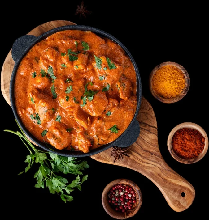 Creamy Indian butter chicken in a black pot
