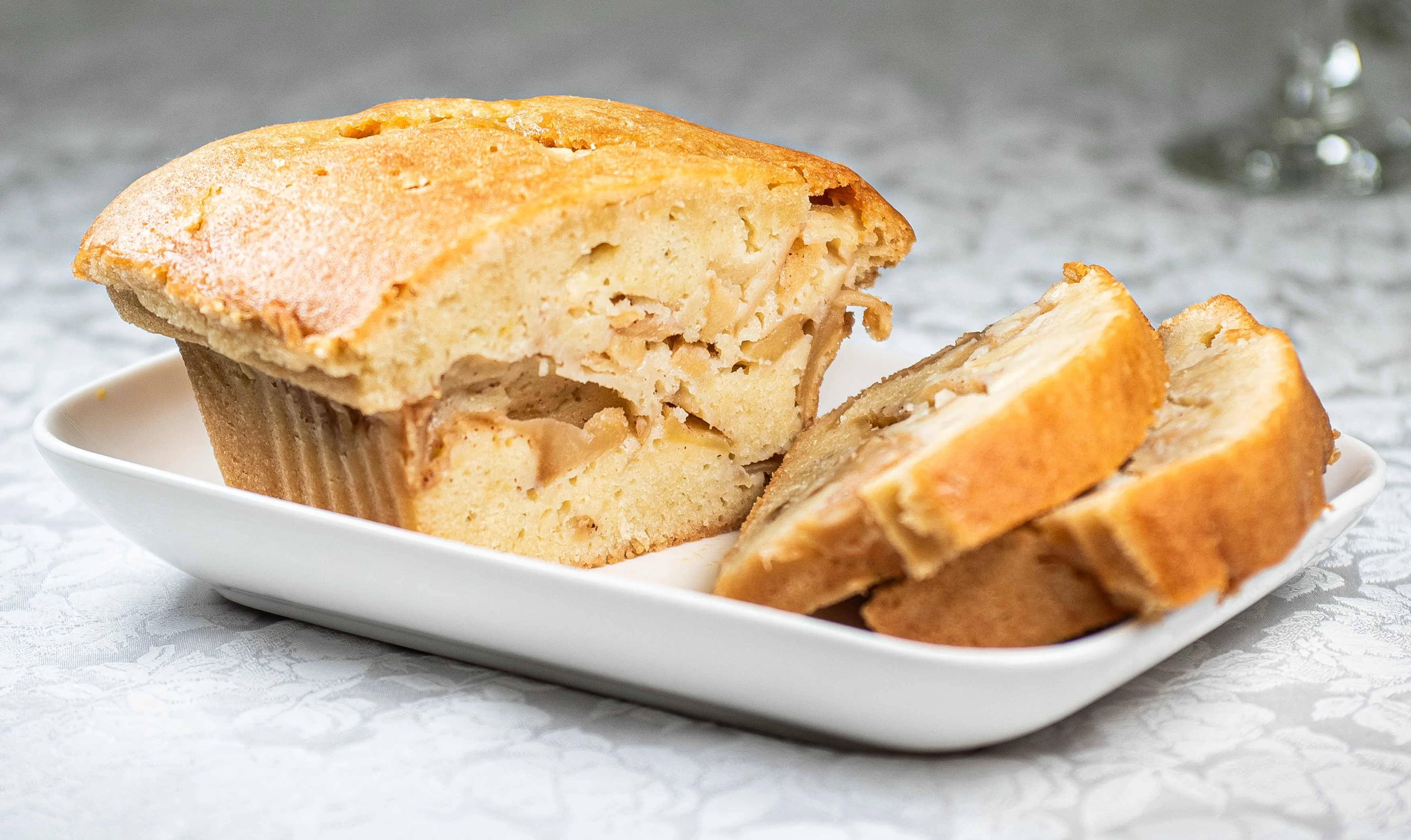 Homemade apple bread loaf on a white plate