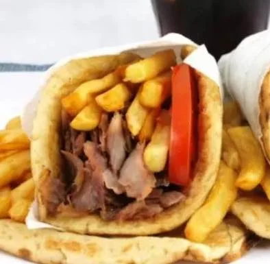 Delicious Turkish döner kebab wraps with fries and fresh tomatoes