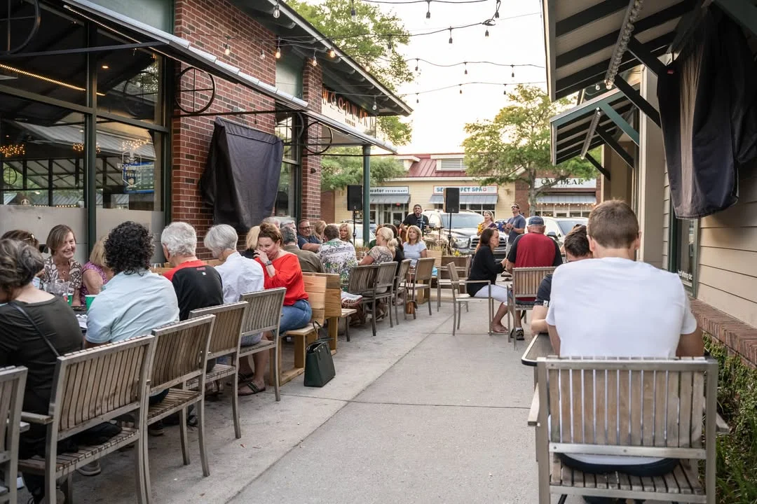 Outdoor dining area with guests enjoying a lively atmosphere