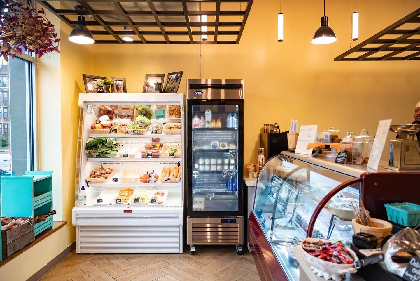 Charming café interior with fresh produce display and dessert counter