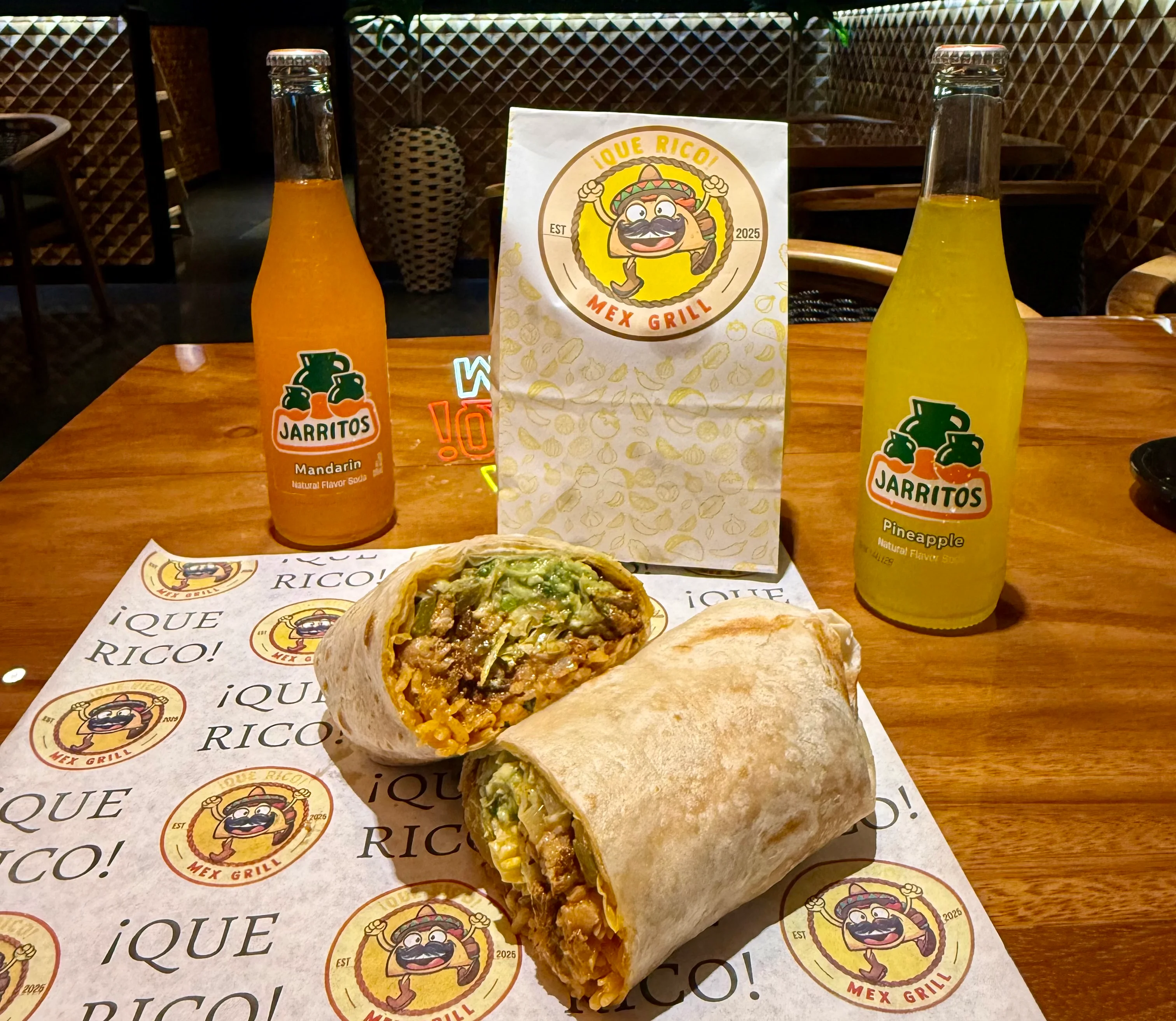Delicious burrito from a Mexican grill with vibrant drinks