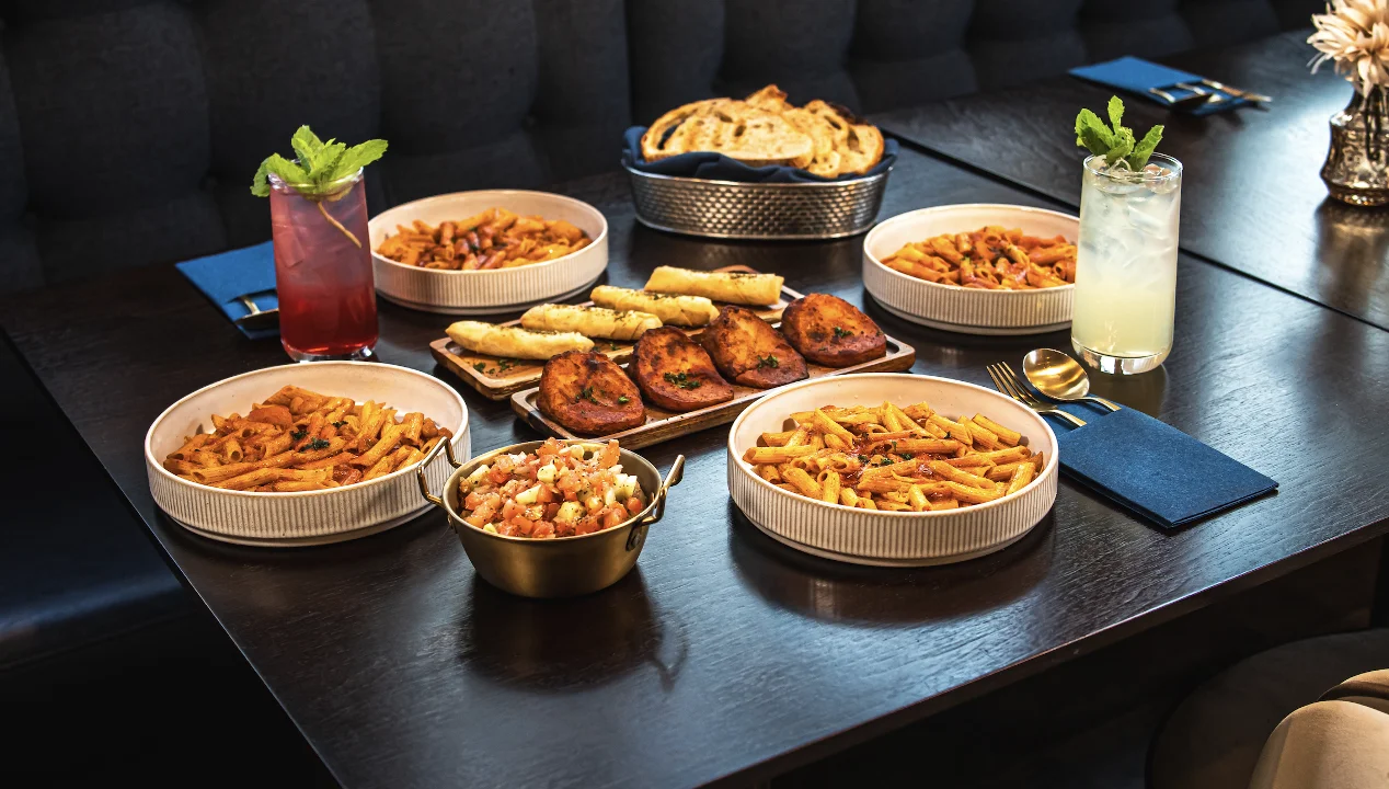 The Sultan catering package from Tripoli's, featuring a halal spread of rice, grilled proteins, dips and salads