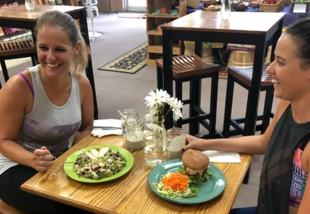 Healthy salad and veggie burger in a cozy cafe setting