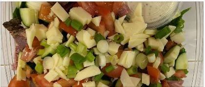 Fresh garden salad with grilled steak and cheese