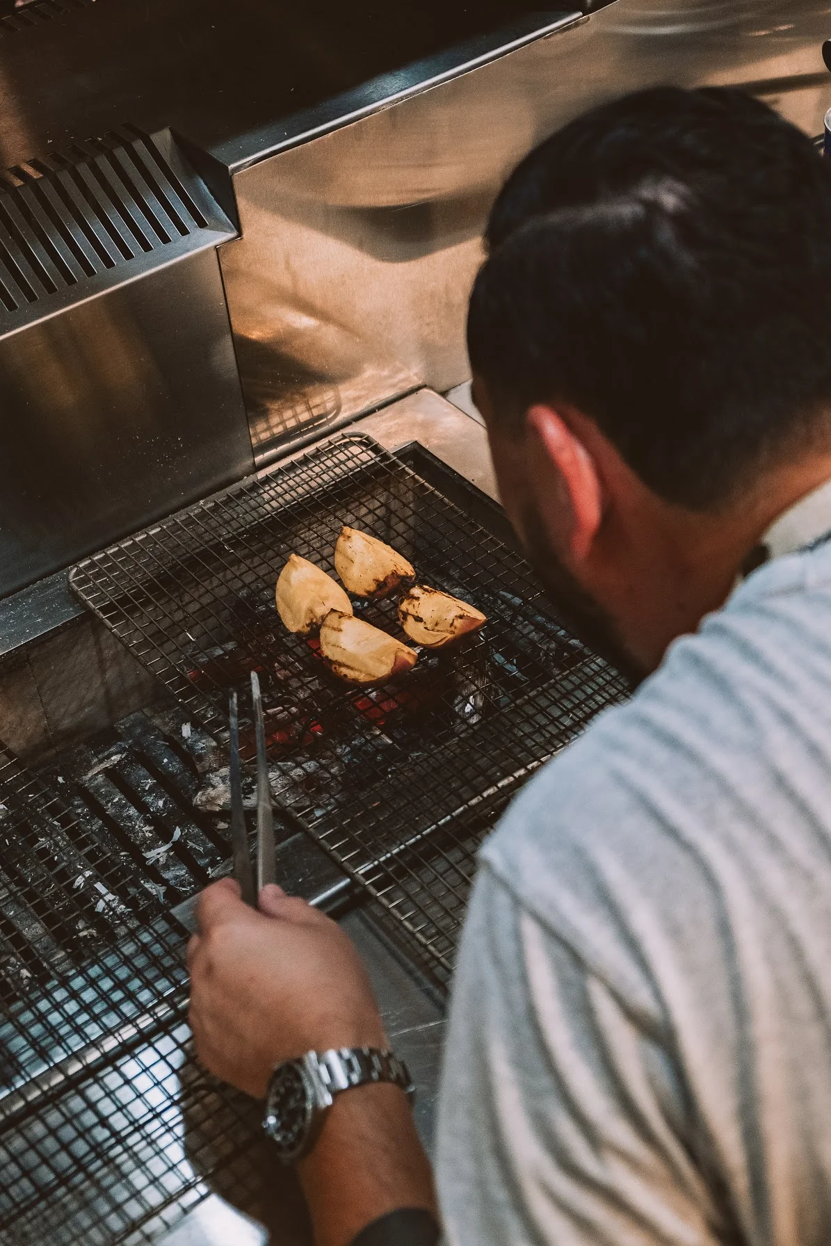 Grilled tacos al pastor on a charcoal grill
