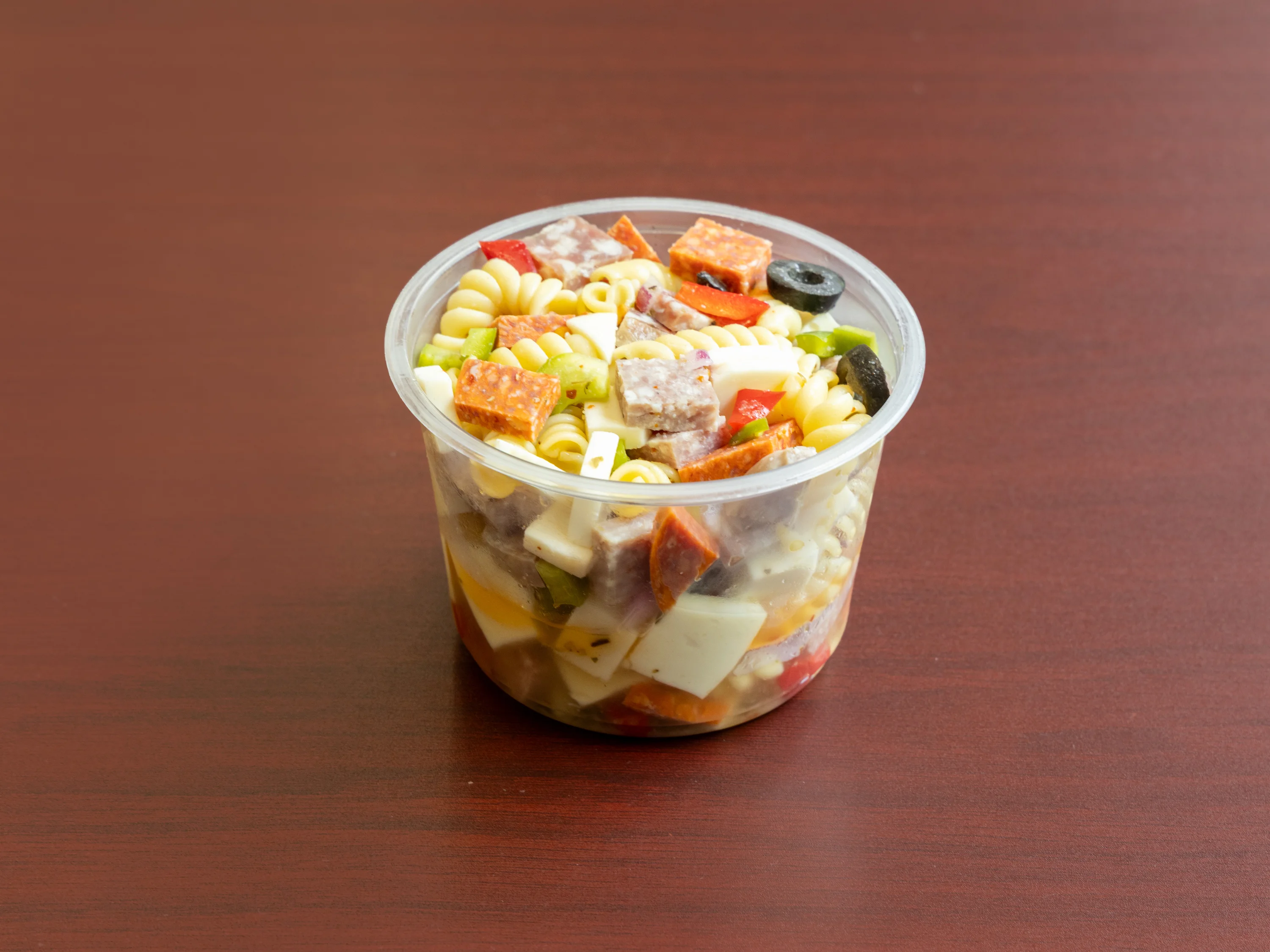 Italian pasta salad in a clear container