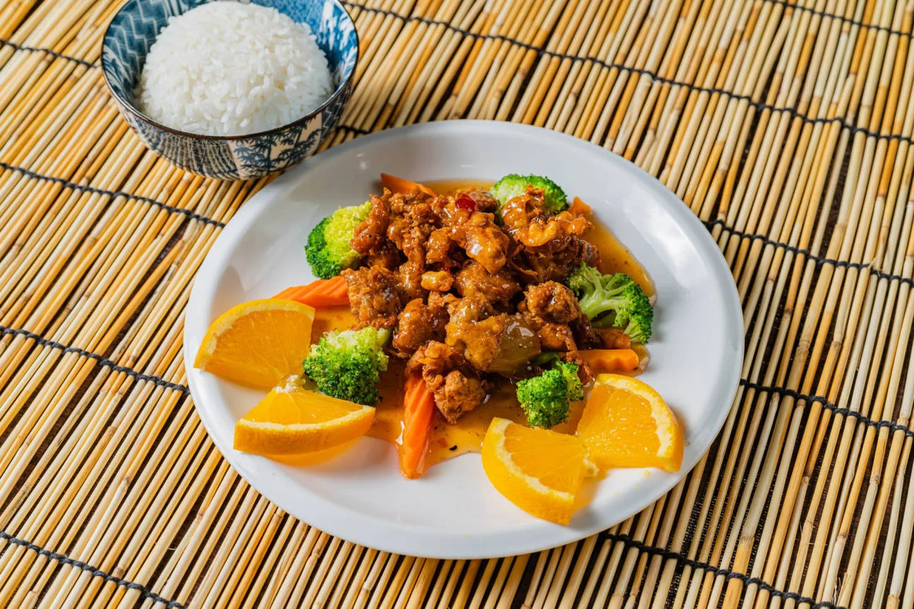 Orange chicken served with broccoli and rice