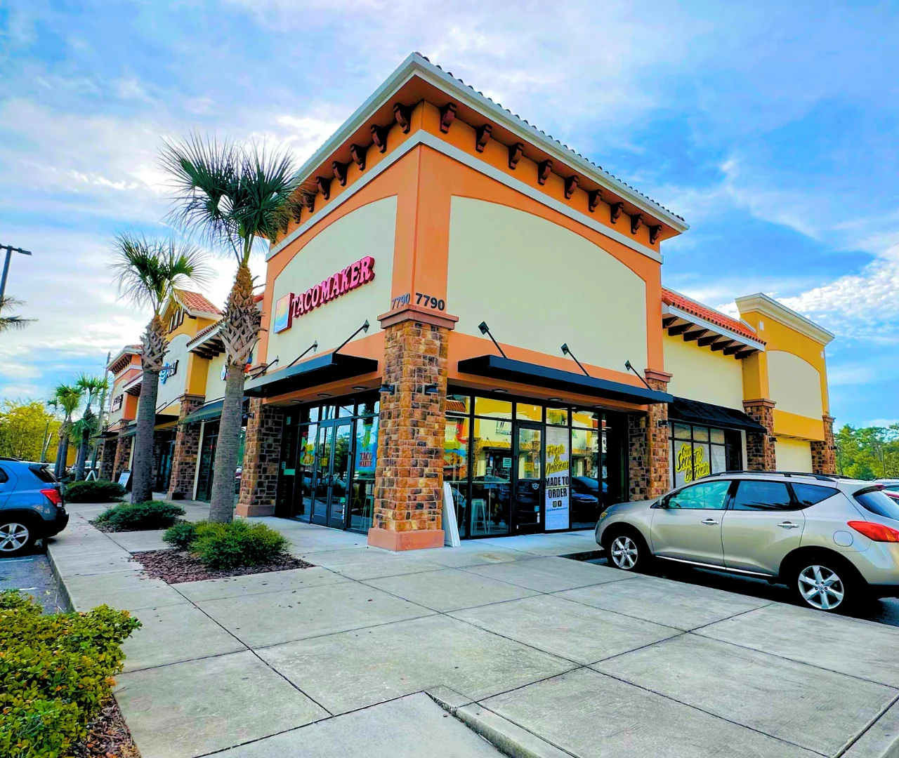 Exterior view of Taco Maker restaurant with palm trees