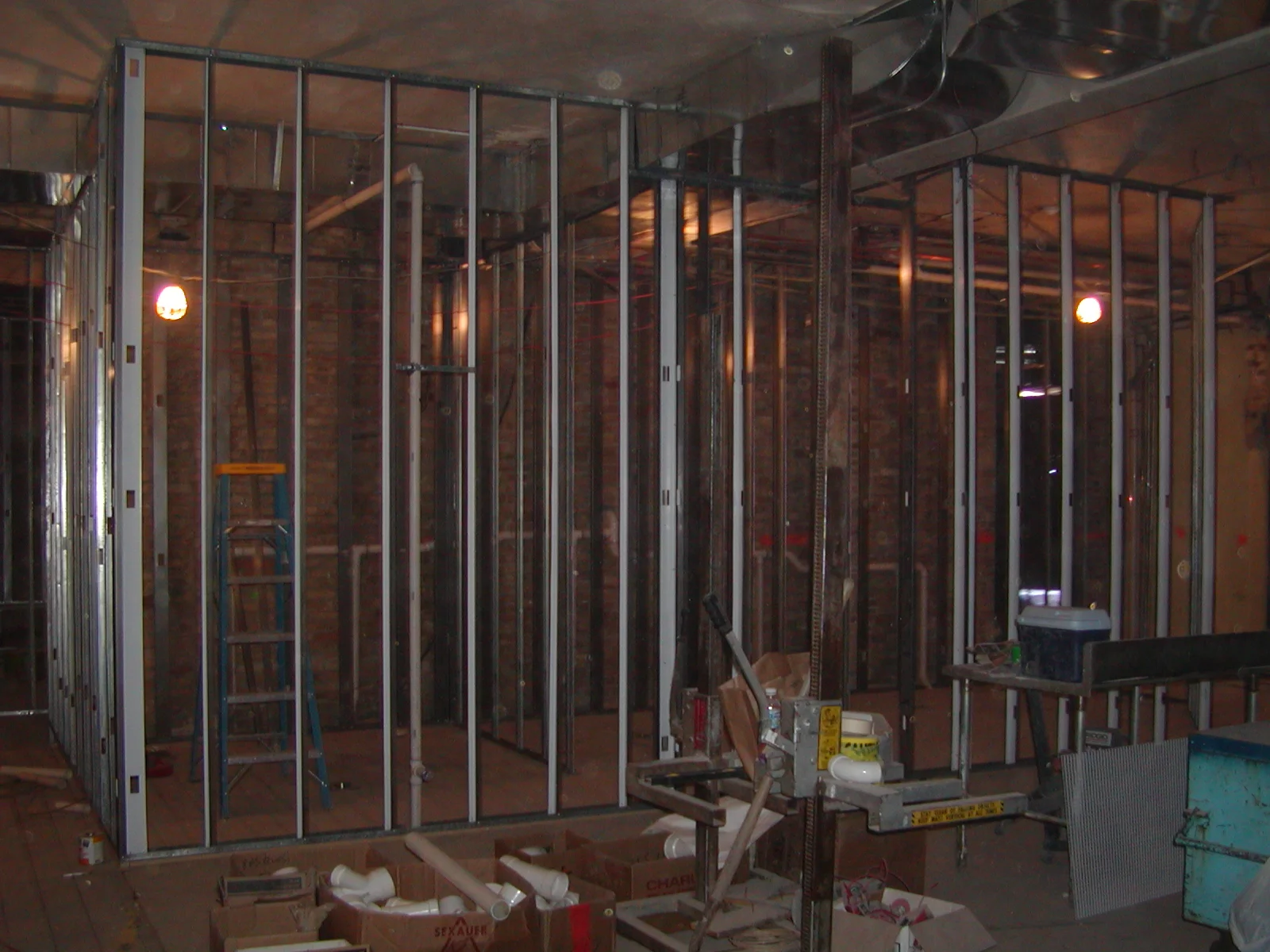 Construction site with metal framing and tools for restaurant renovation