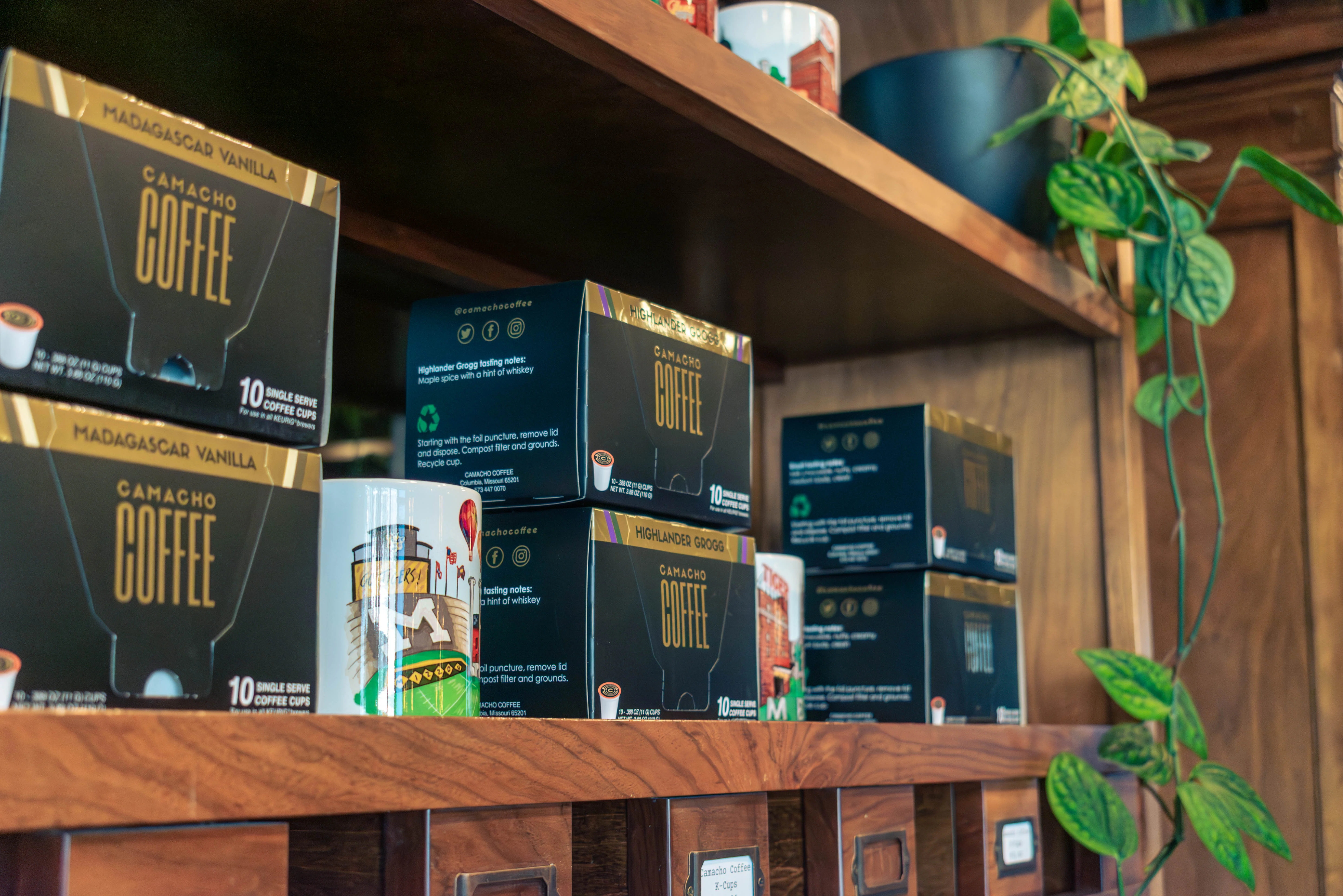 Packages of Camacho Coffee on wooden shelves