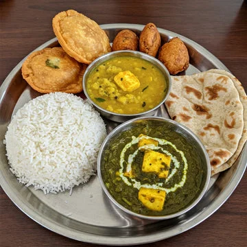Traditional Indian thali with rice, curries, and bread