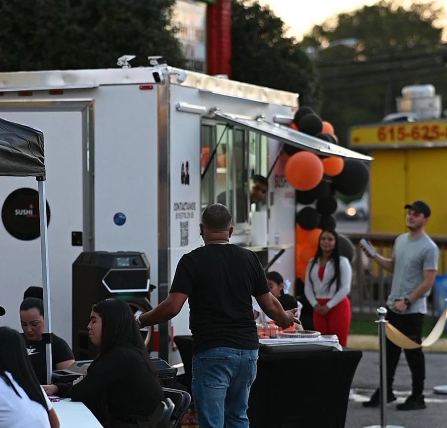 Food truck event with sushi offerings and outdoor seating