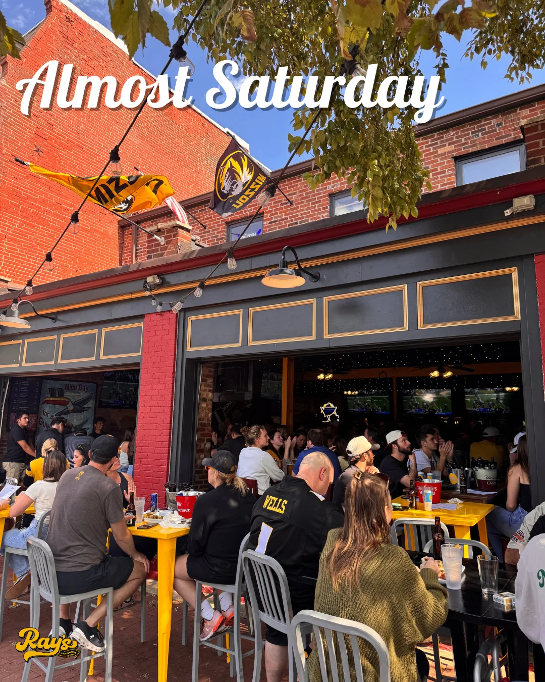 Lively outdoor dining scene at a sports bar