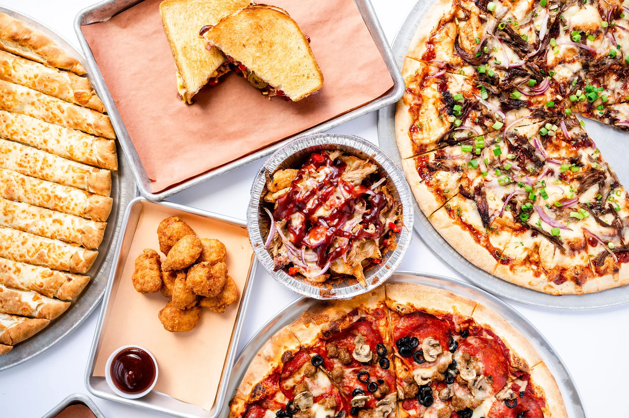 Assorted pizzas and comfort food platter