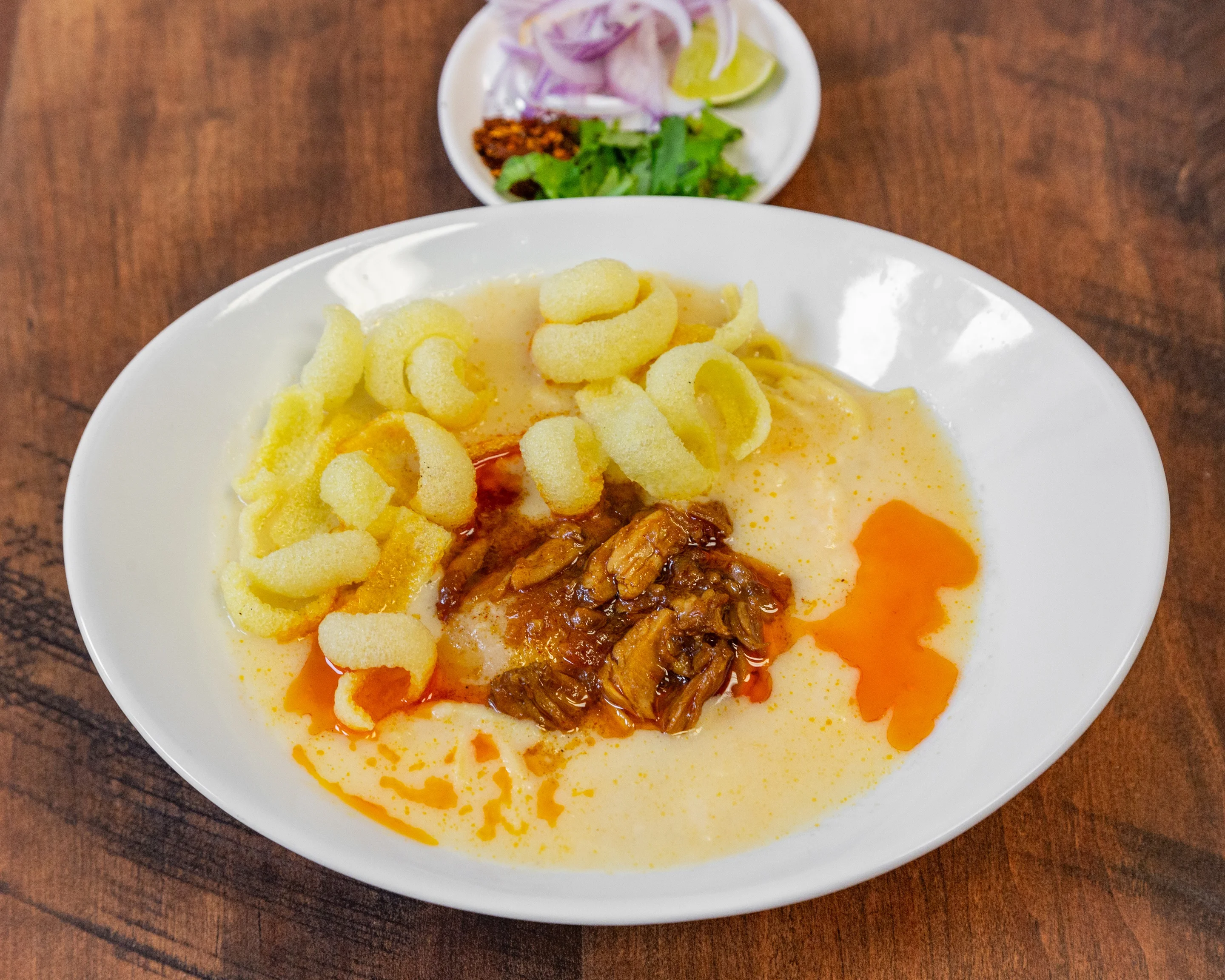 Indonesian soto with crispy crackers and garnishes