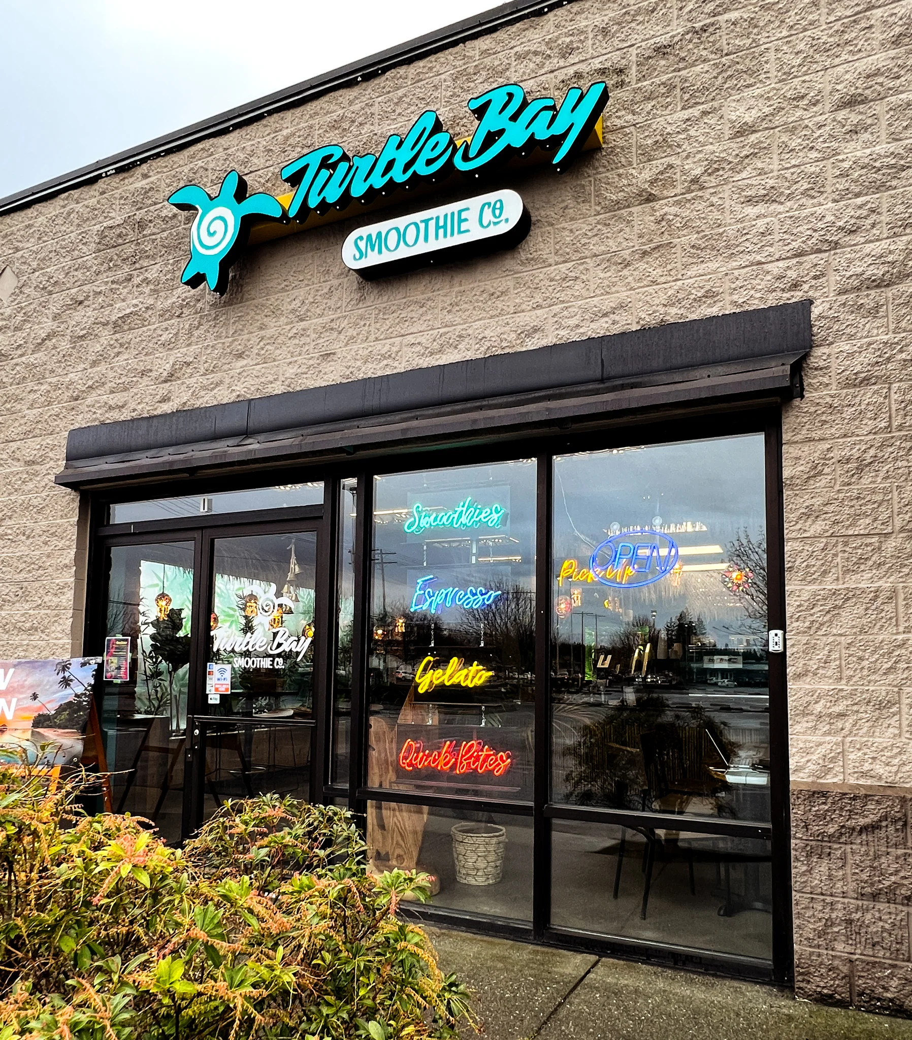 Turtle Bay Smoothie Co. logo with a beach sunset background