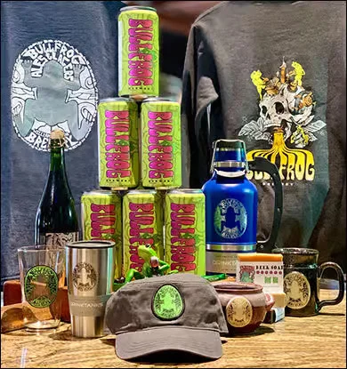 Collection of Bullfrog Brewing merchandise and craft beer cans