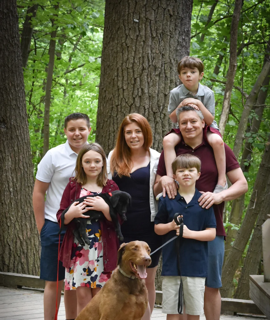 Family portrait in a forest with pets