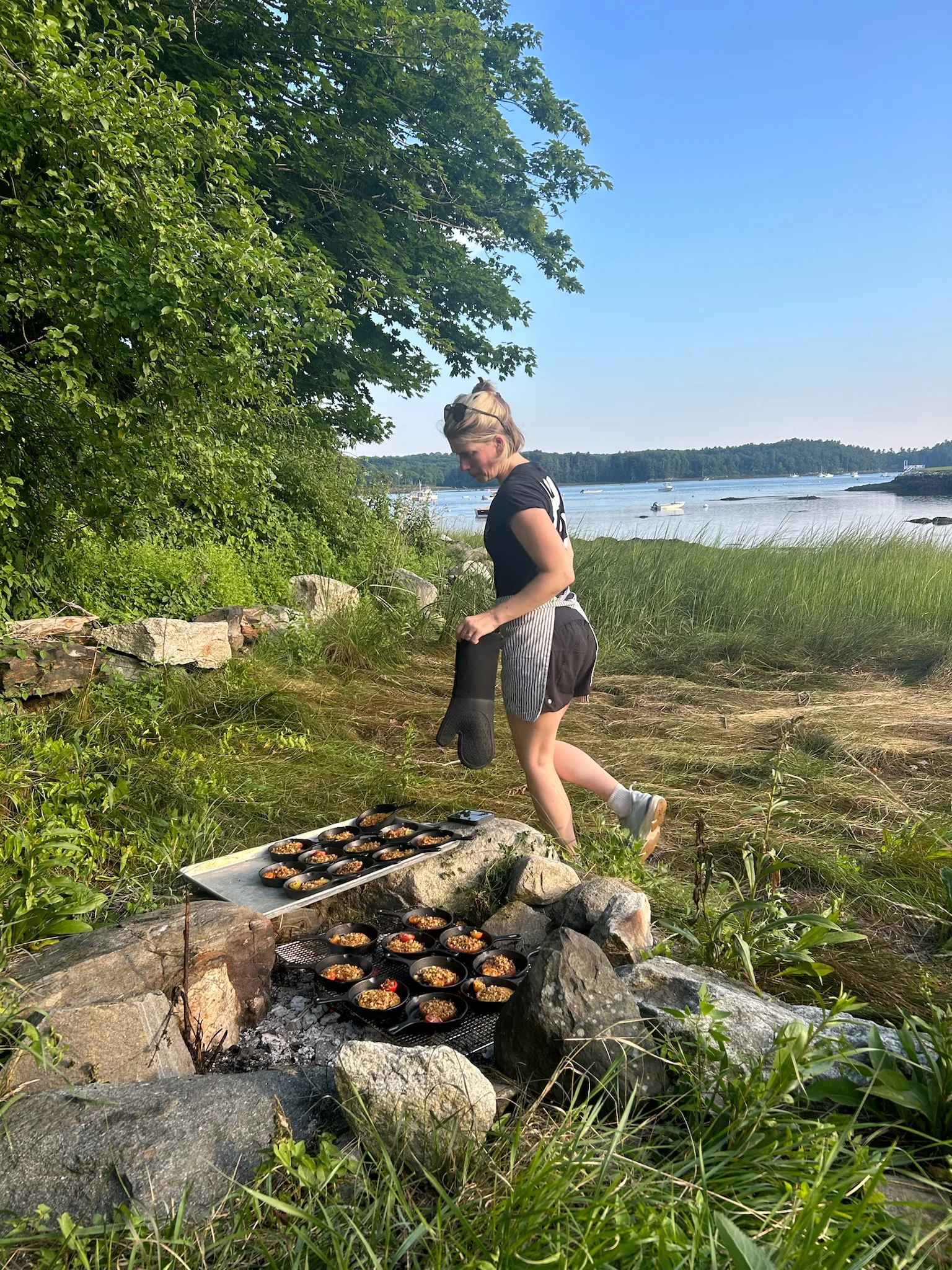 Outdoor cooking with cast iron pots by the water