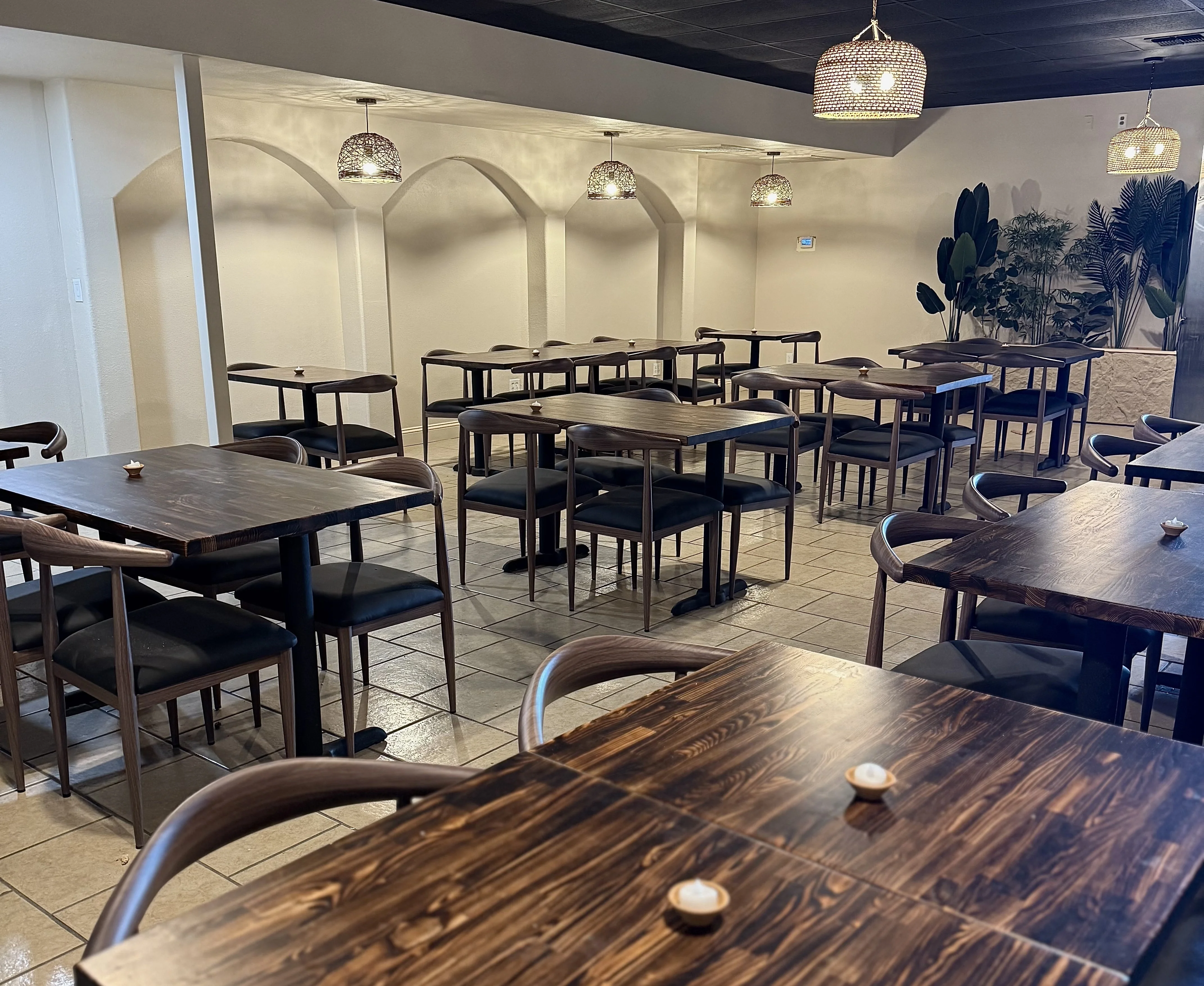 Modern restaurant interior with wooden tables and stylish lighting