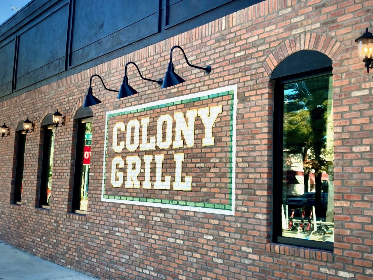 Exterior view of Colony Grill restaurant with brick facade