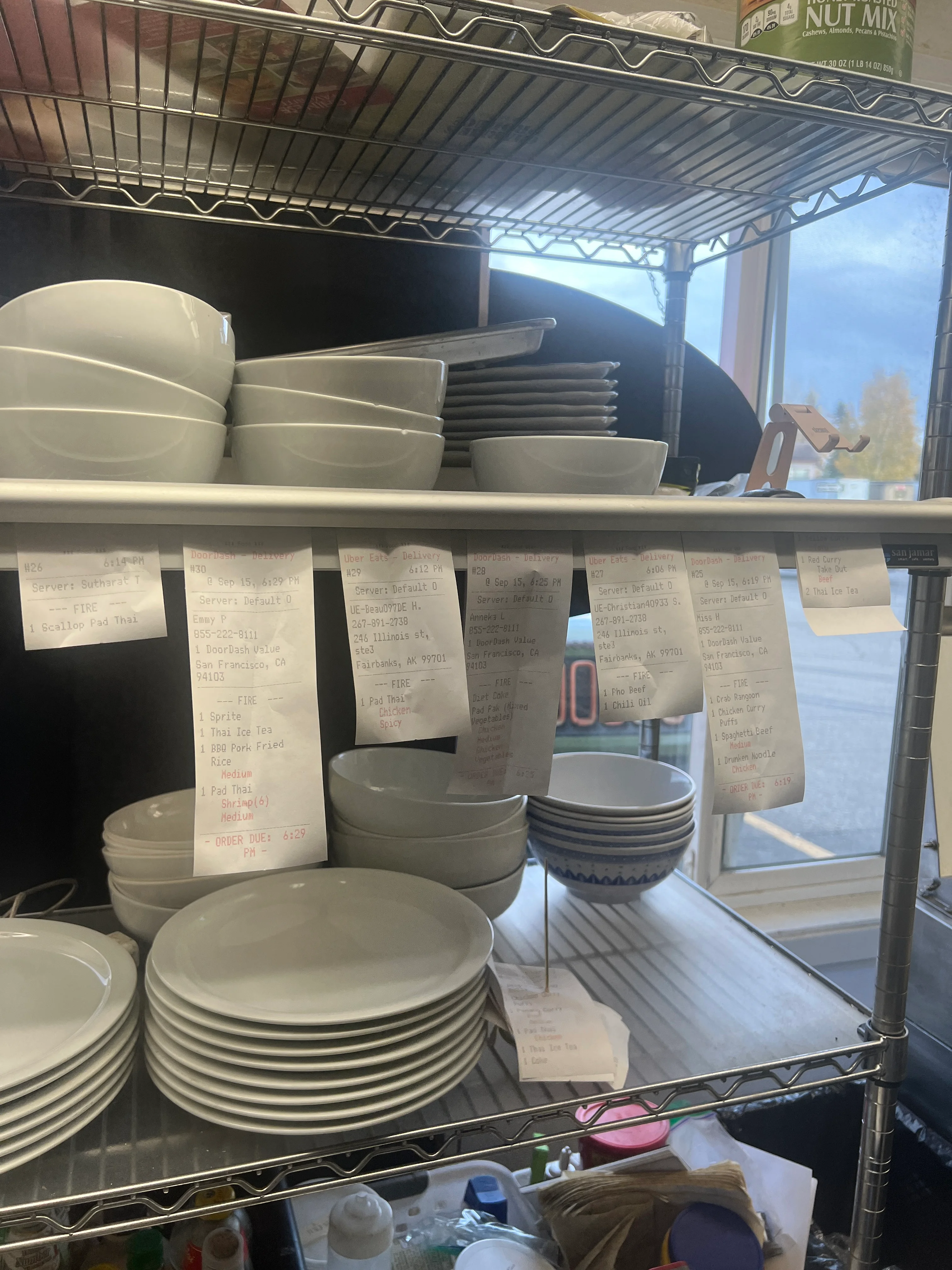Restaurant kitchen with stacked plates and order tickets