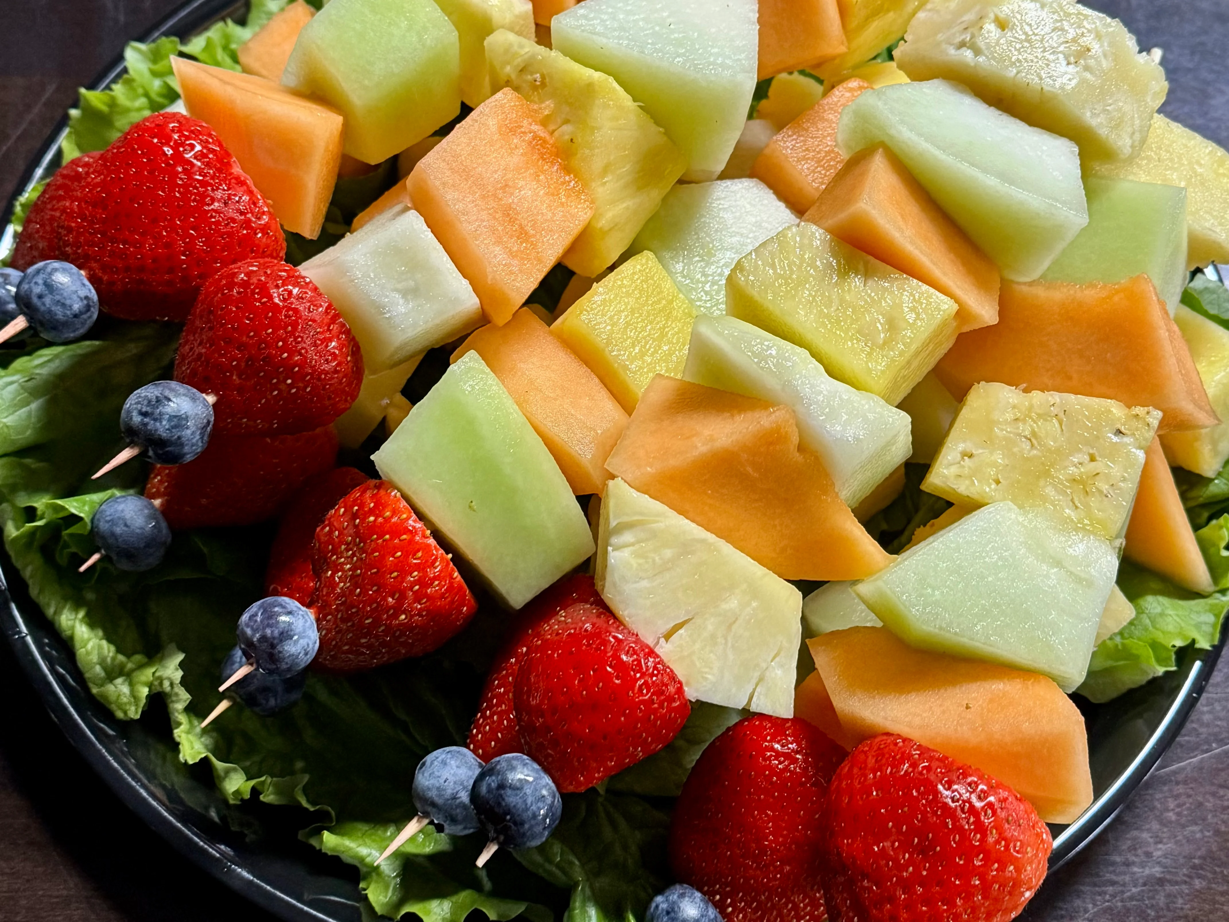 Colorful fruit salad platter with strawberries and blueberries