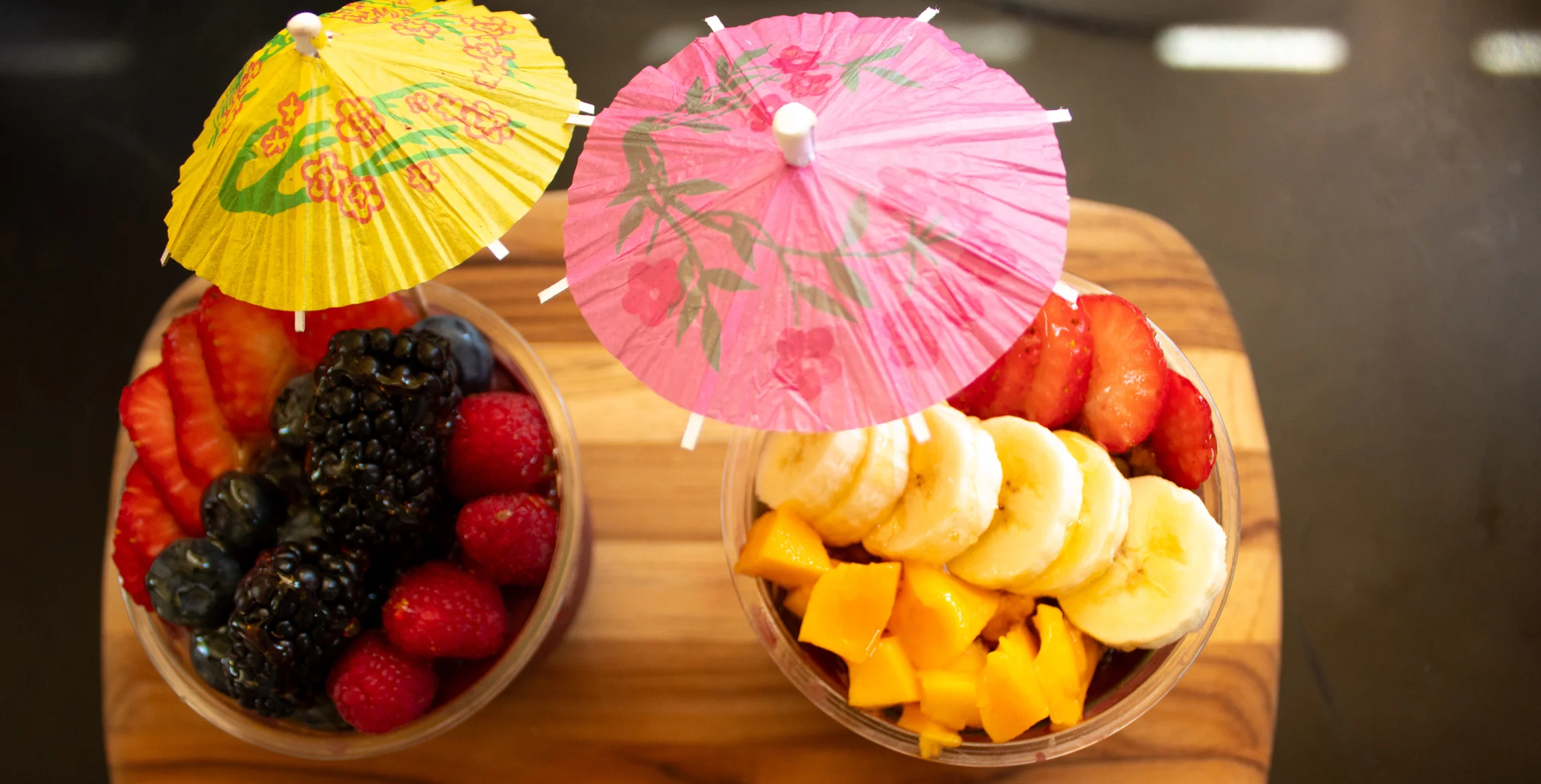 Colorful fruit cups with tropical umbrellas