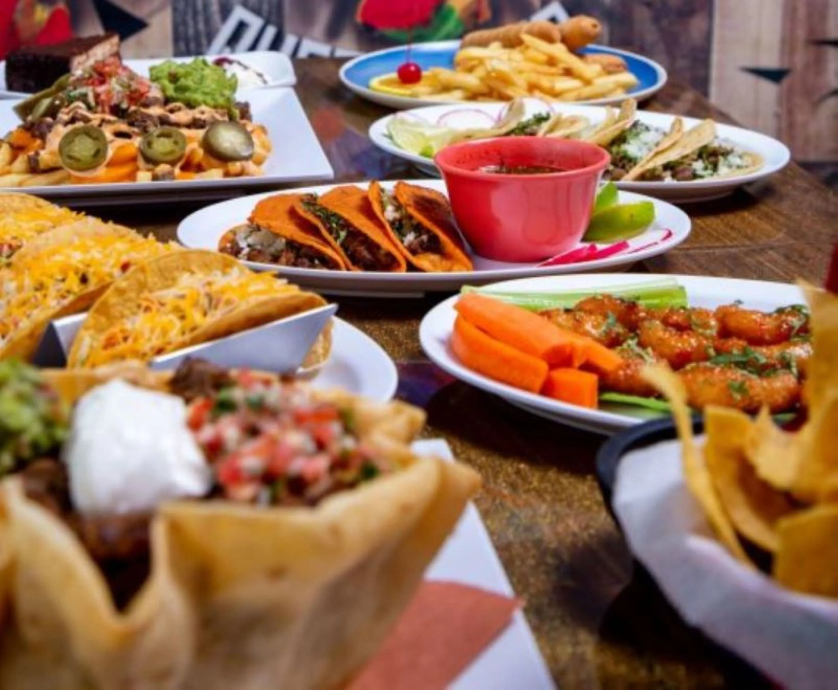 Colorful Mexican taco platter with various toppings