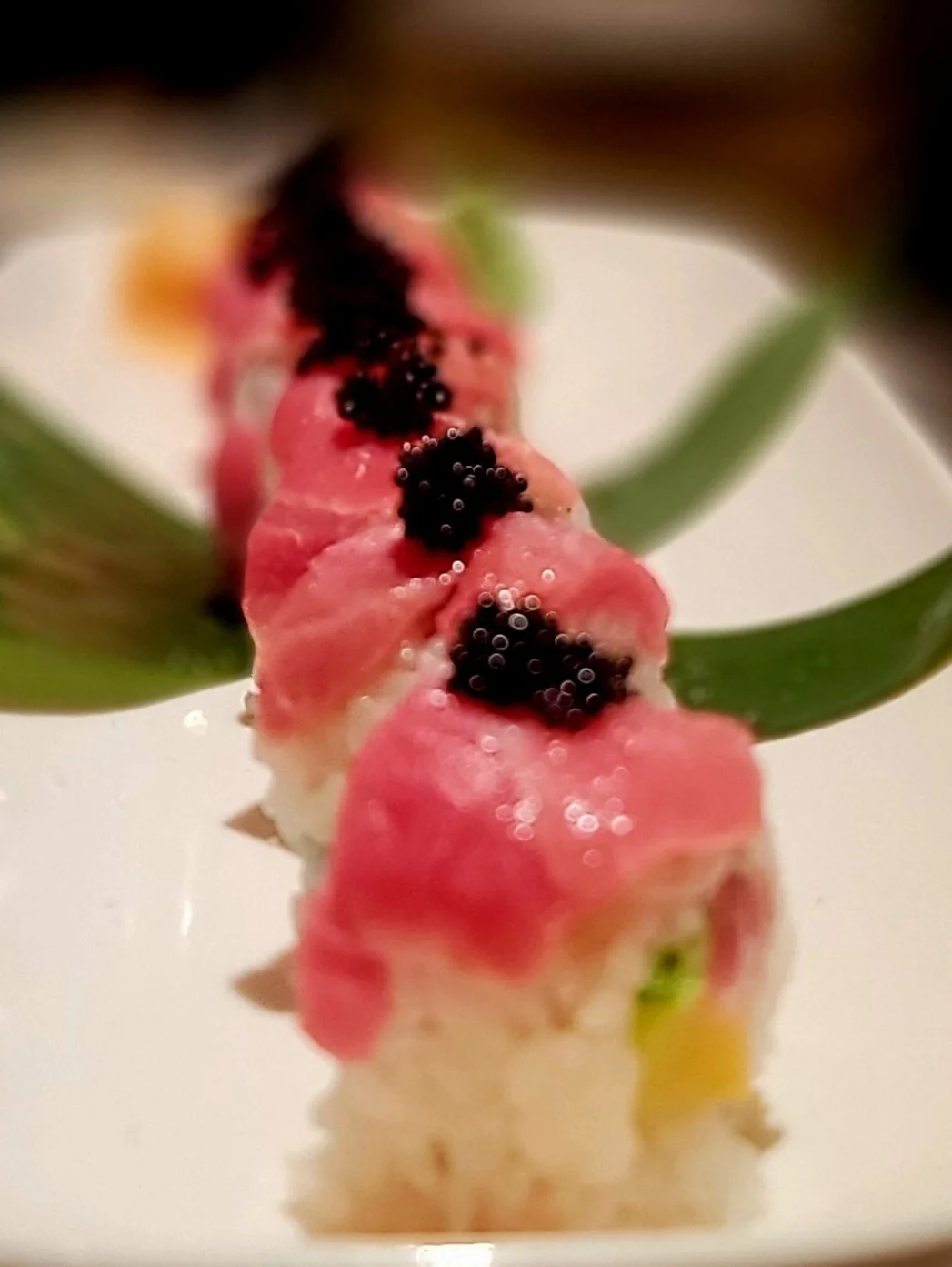 Japanese sushi roll topped with fresh tuna and caviar