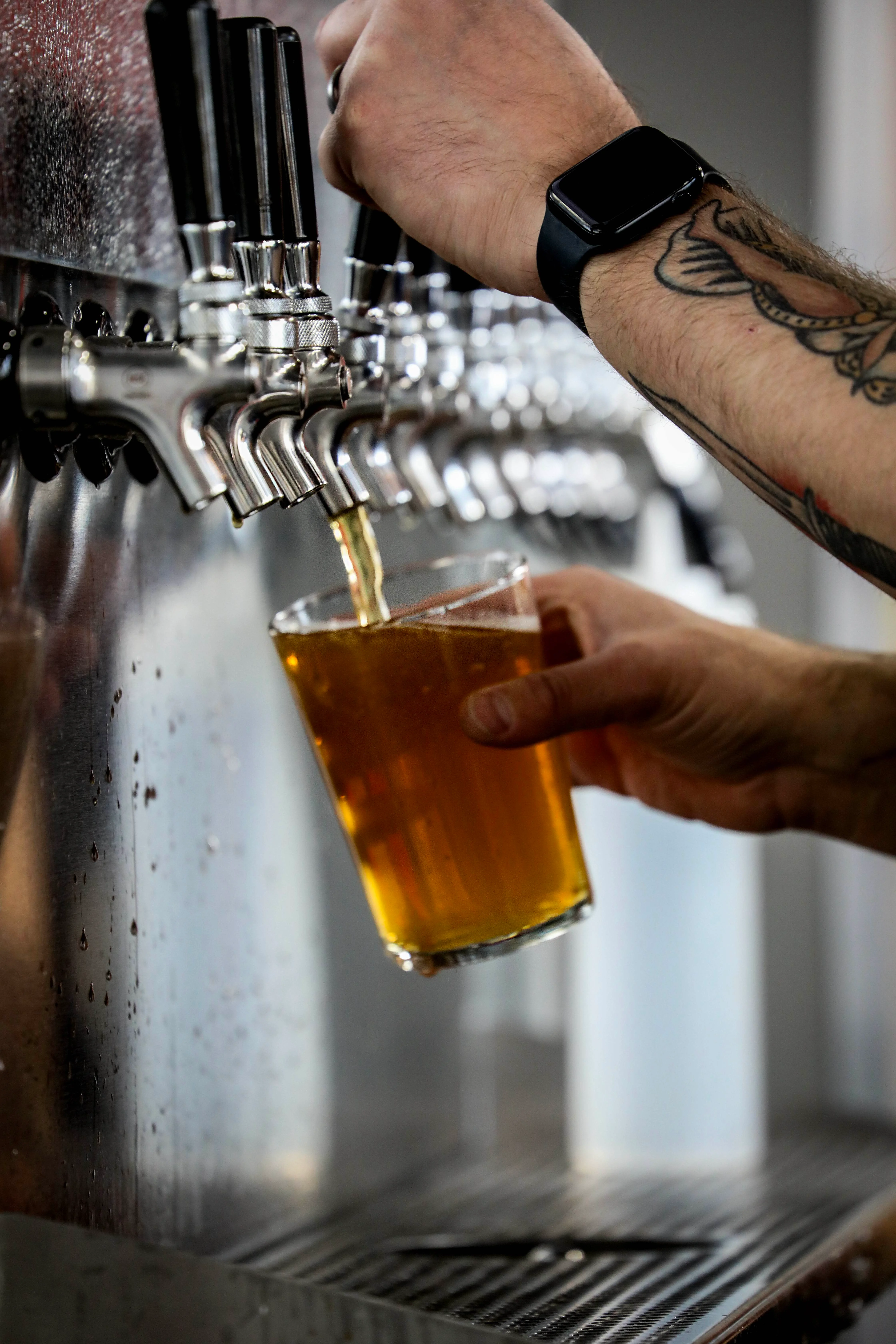 Draft beer pouring into a glass